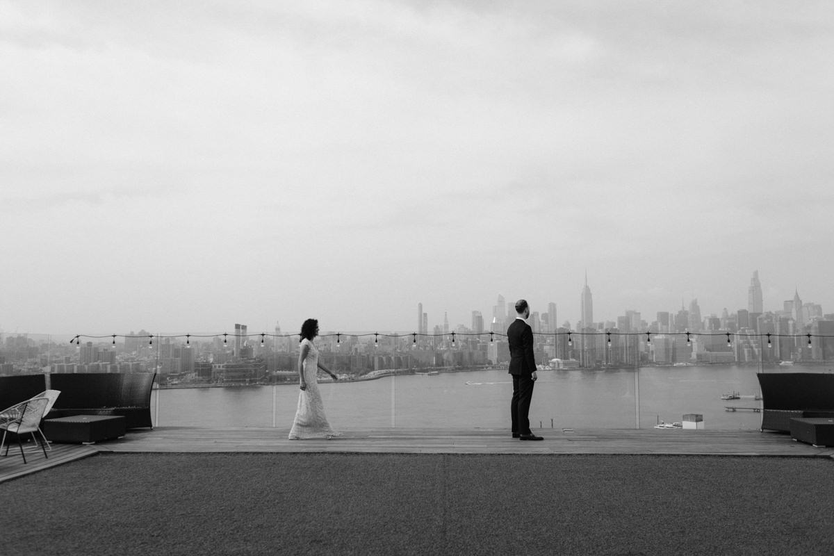 New York wedding photographer Jenny Fu takes pictures of a couple on a rooftop in Brooklyn