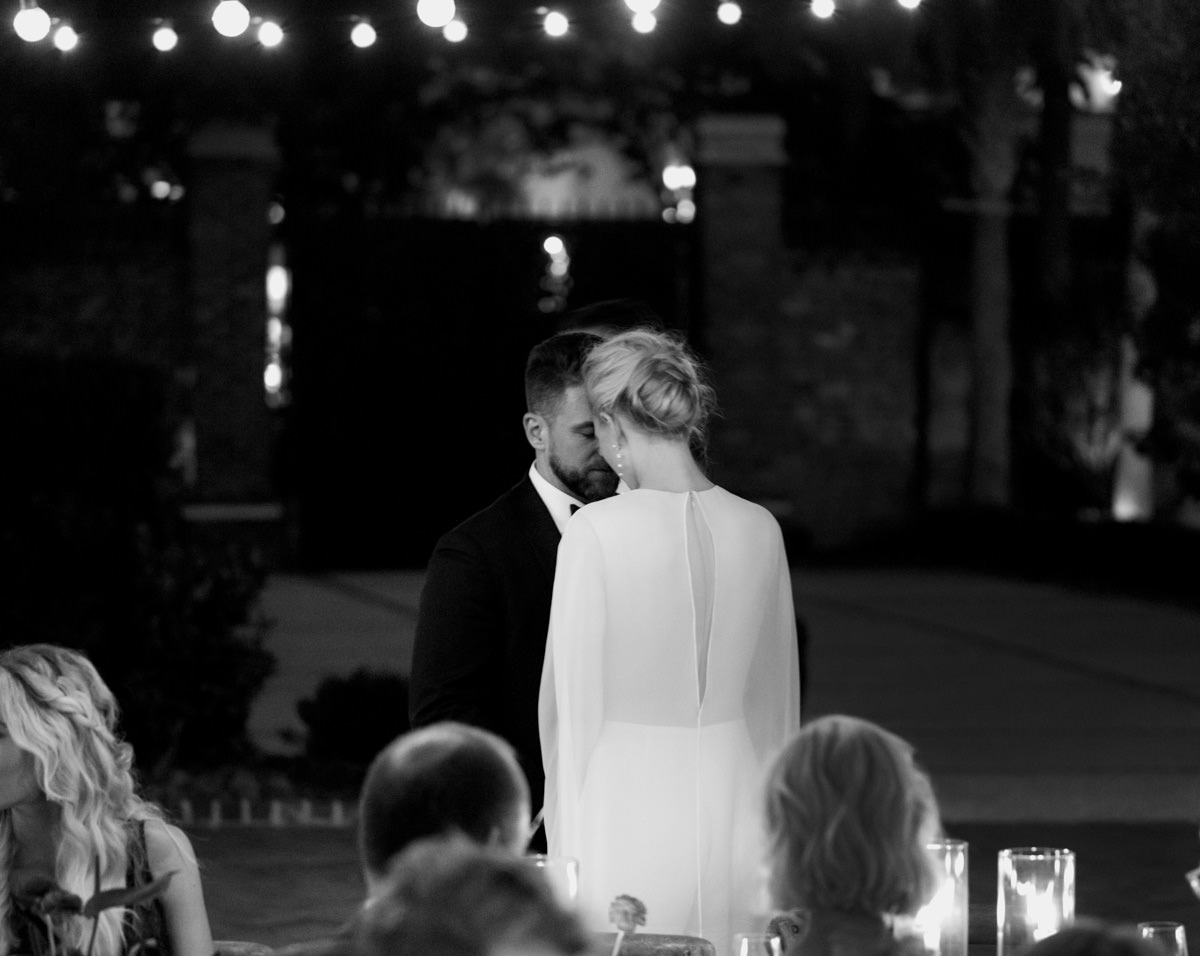 Bride and groom share an intimate moment at their wedding reception