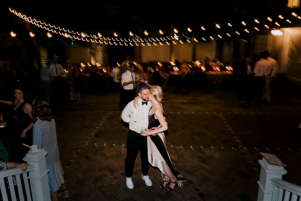 Newlyweds dance under string lights