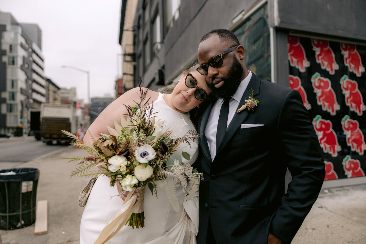 Biracial bride and groom walk through the streets of New York City for their wedding photography