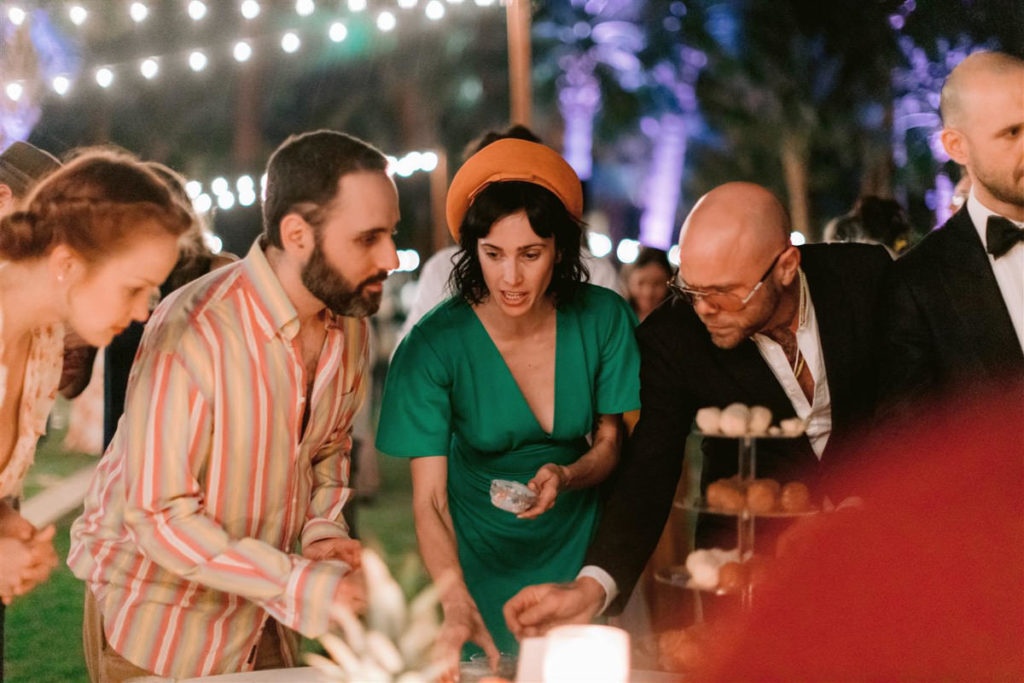 Guests of an at-home wedding in Palm Springs reach for dessert