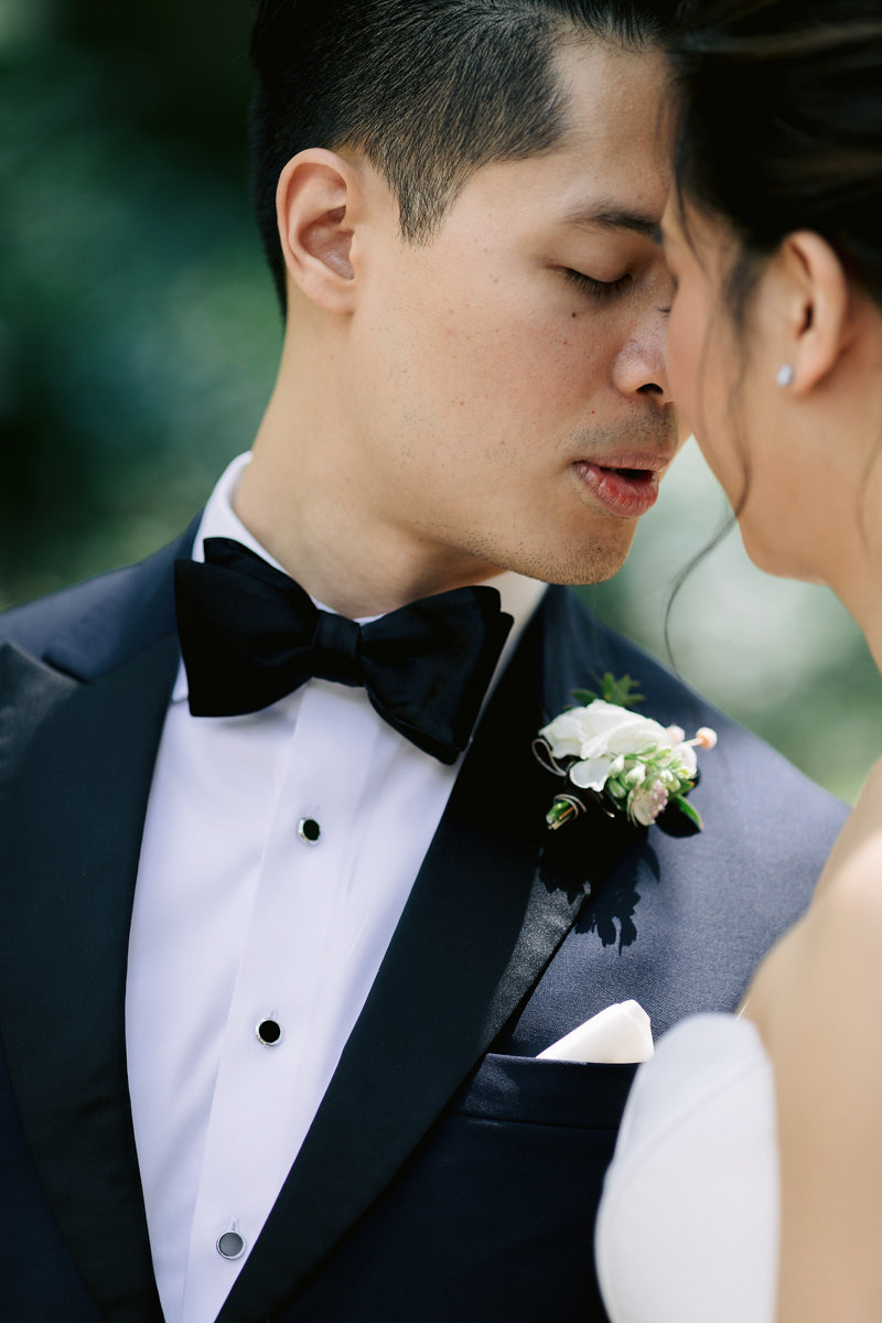 The groom, with eyes closed, is about to kiss the bride at a wedding in NYC. Image by Jenny Fu Studio 