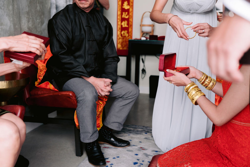 An Asian American family opens gifts together on the morning of their daughers wedding