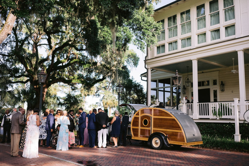 Wedding parties convene on the front lawn of a reception site