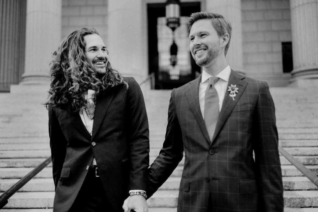 Two men on their wedding day in front of City Hall in NYC
