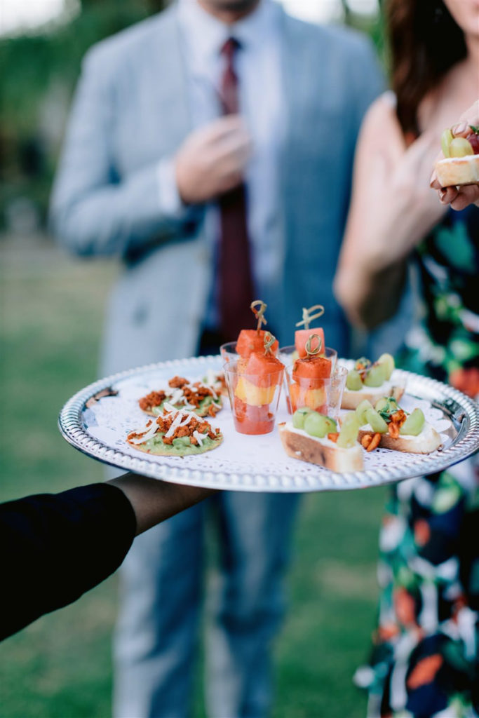 Pre-wedding cocktails and snacks are handed out by a waiter