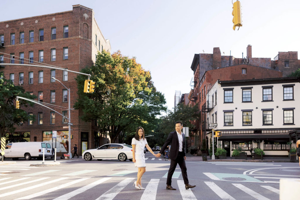 The engaged couple is crossing the pedestrian lane at West Village, NYC. Image by Jenny Fu Studio