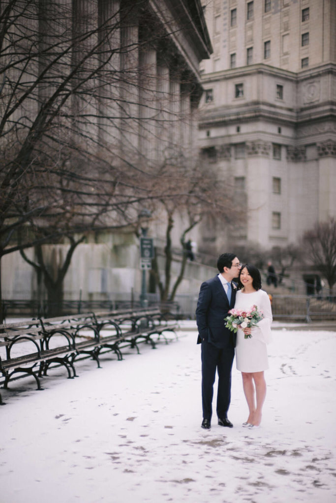 The bride and groom are having a winter wedding in New York City hall. Image by Jenny Fu Studio