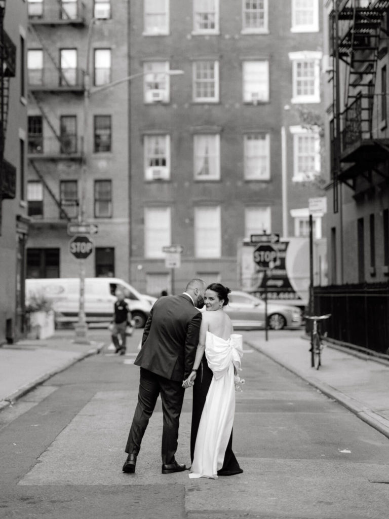 The Engaged man is kissing his fiancée in the middle of a street at West Village, NYC. Image by Jenny Fu Studio