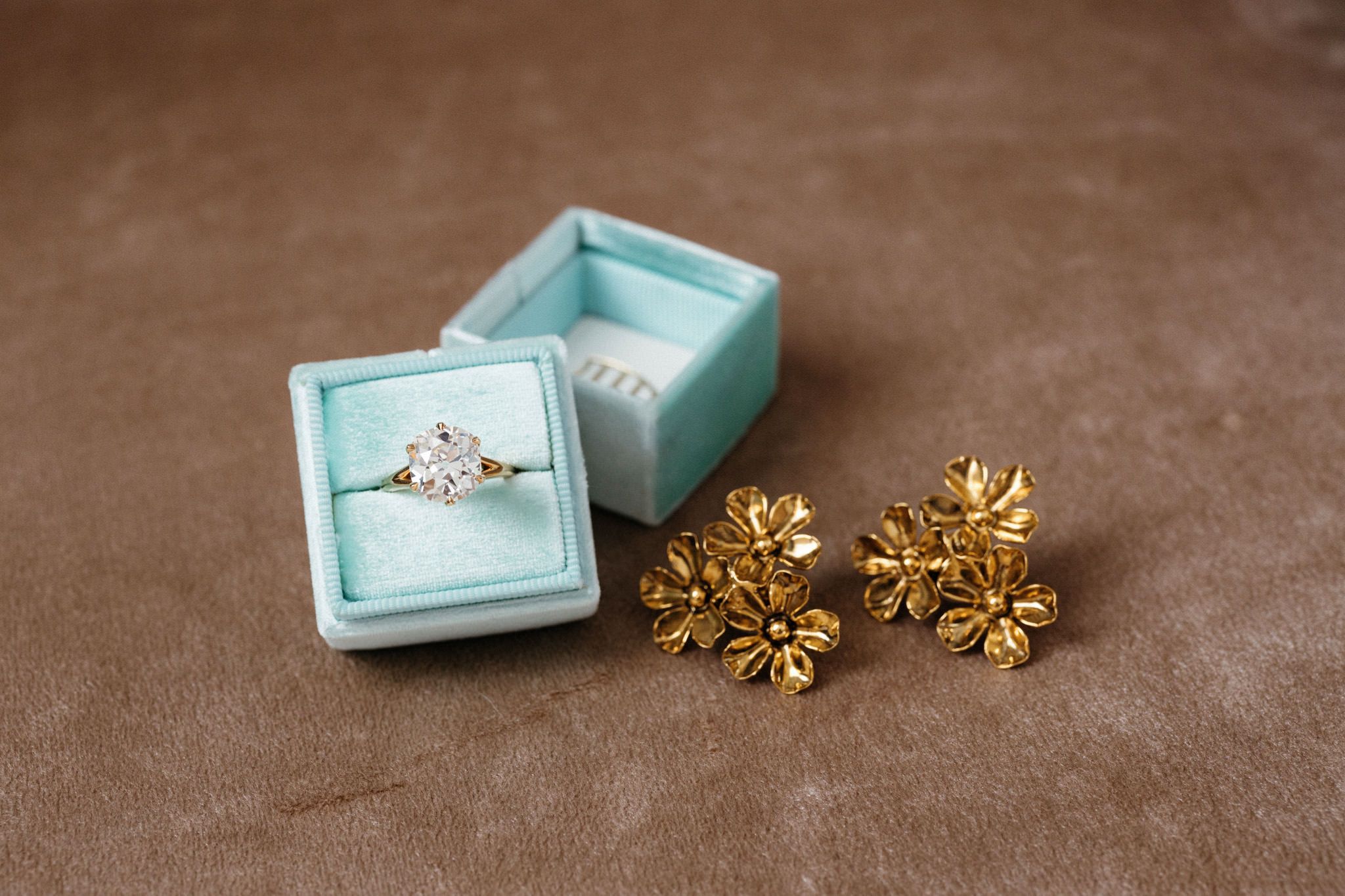 The diamond engagement ring is inside a baby blue box. Image by Jenny Fu Studio