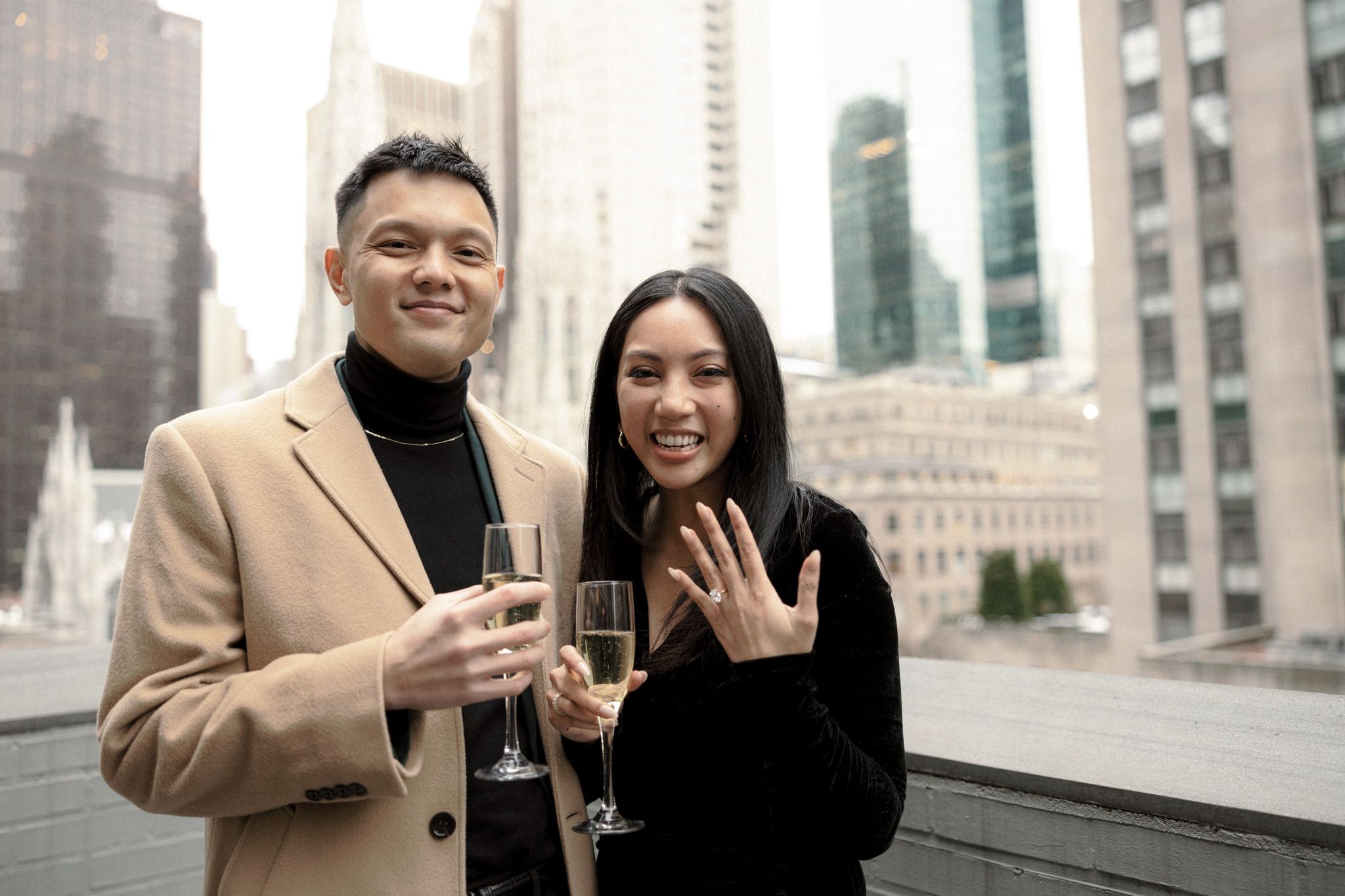 The newly engaged couple are happily drinking champagne after the proposal. Image by Jenny Fu Studio
