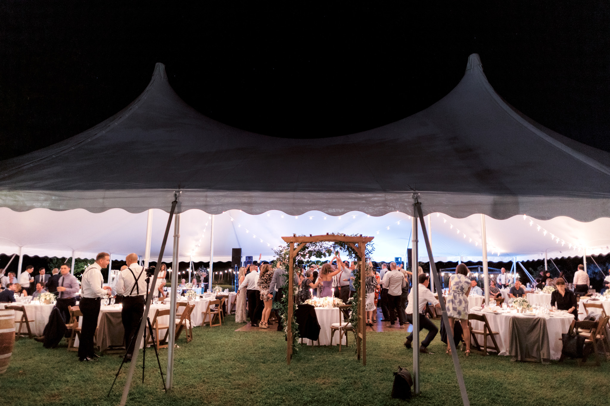 Guests are having fun inside a wedding tent in New York City.
