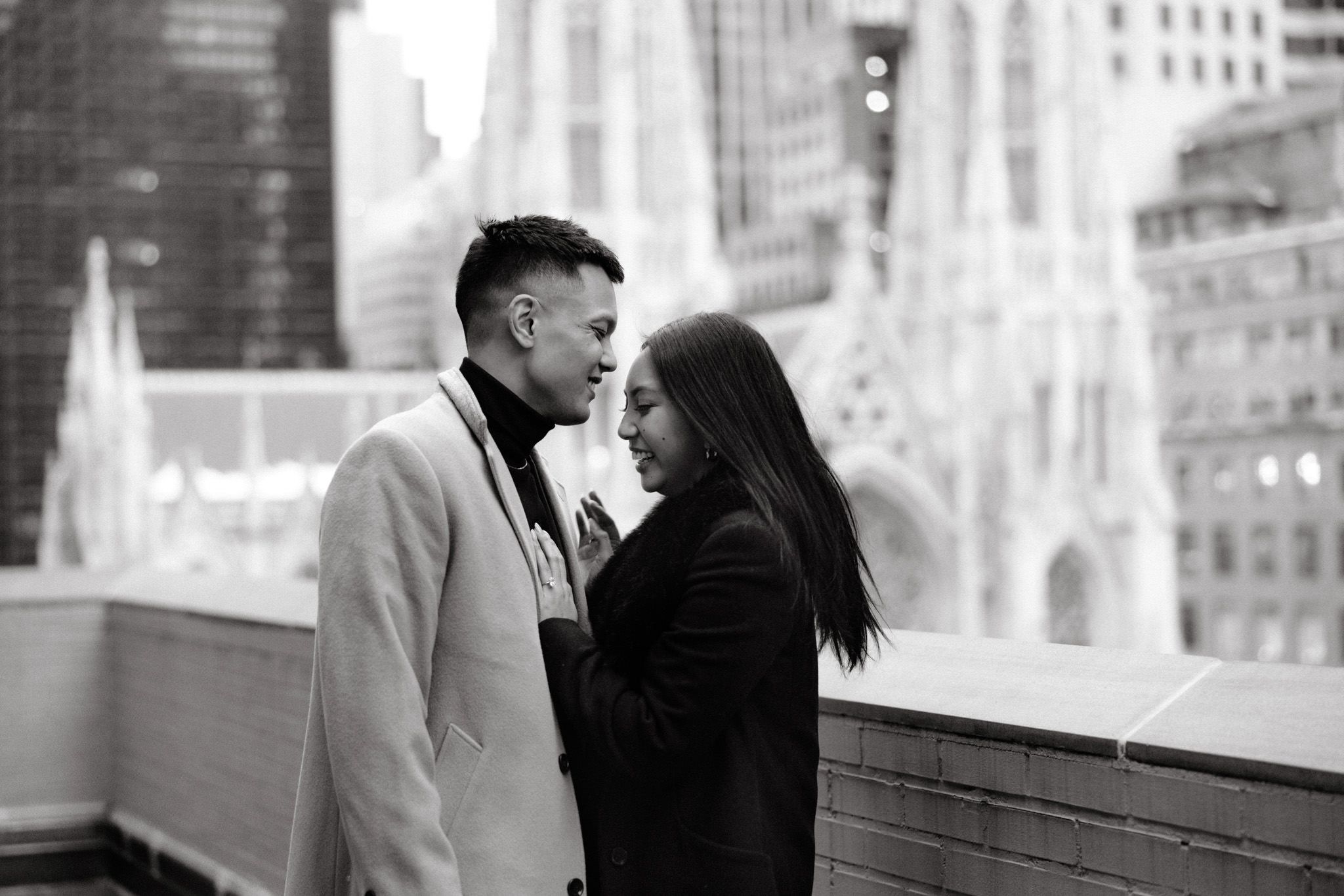 Black and white photo of the engaged couple happily laughing after the proposal. Engagement image by Jenny Fu Studio