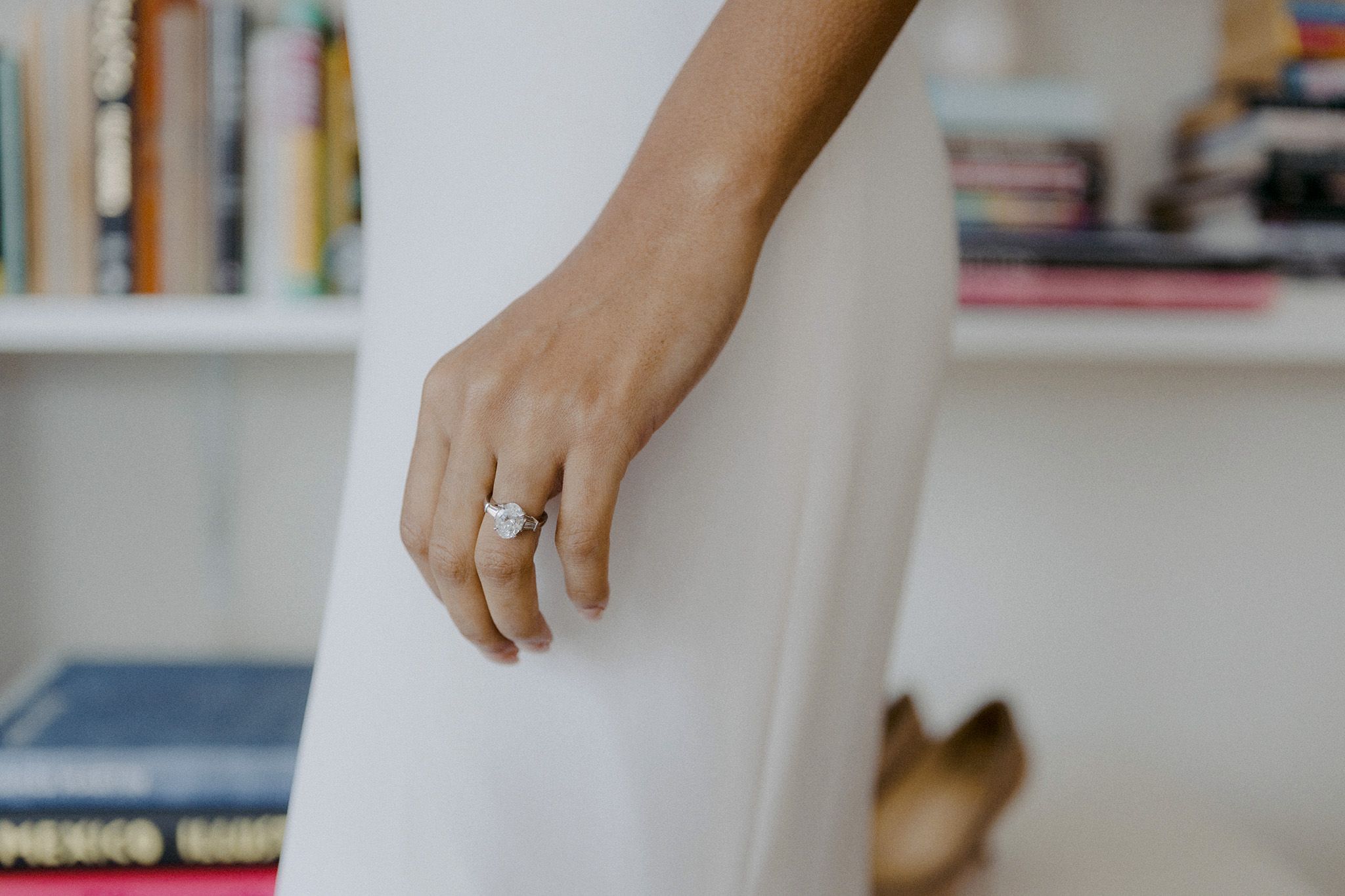 The bride is wearing her oval-shaped diamond engagement ring. Image by Jenny Fu Studio