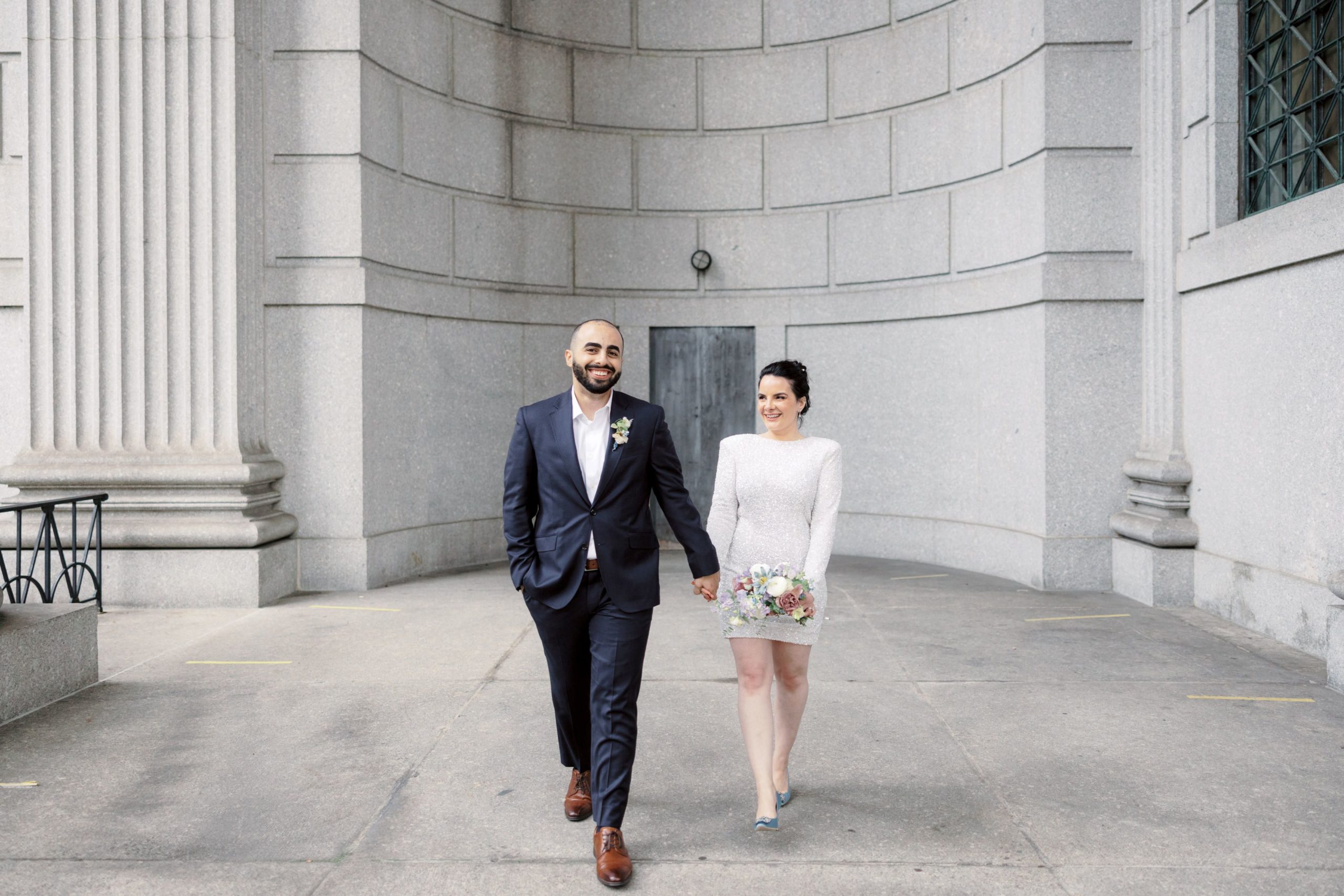 The bride and groom are walking happily. Image by Jenny Fu Studio NYC