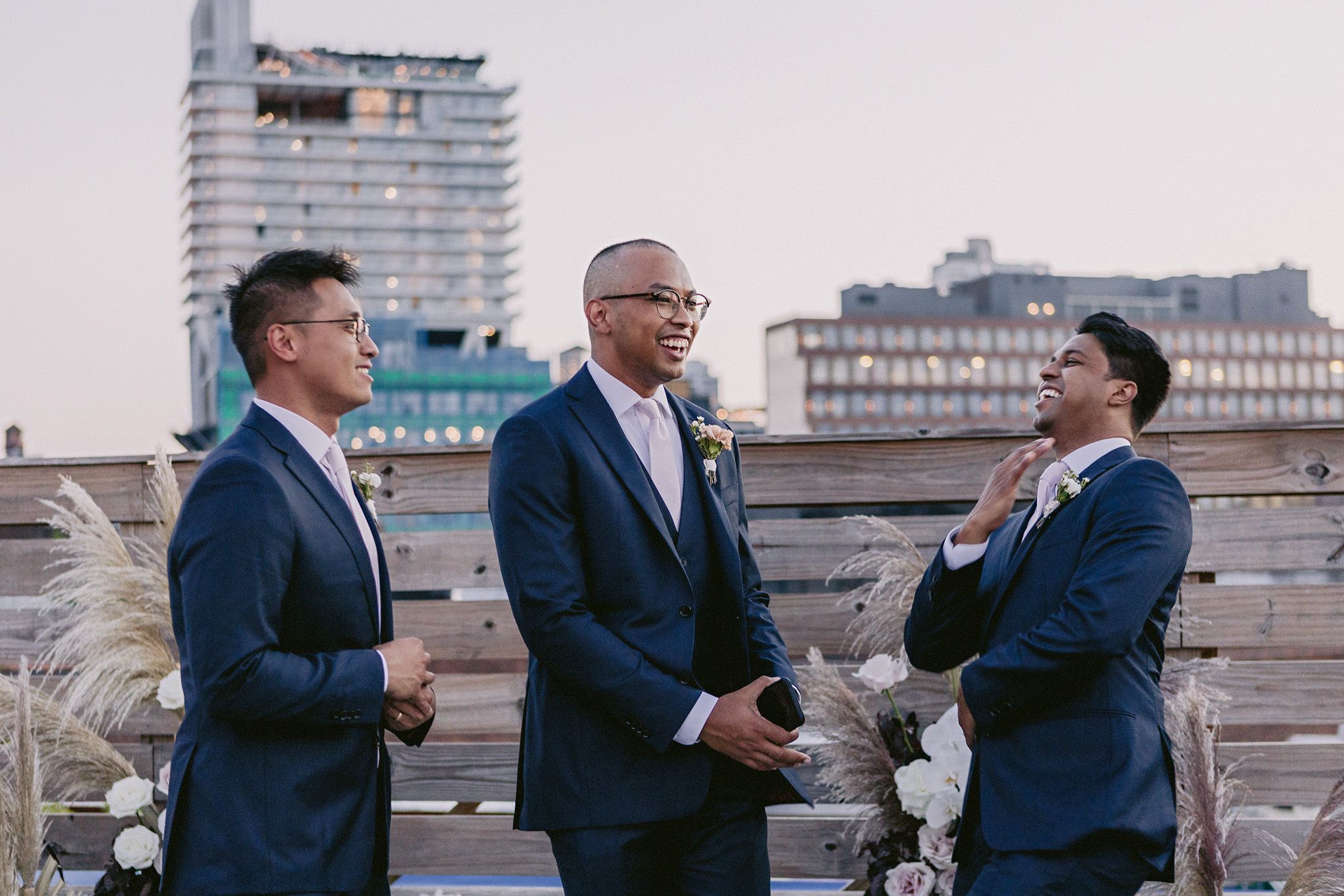 The groom is chatting happily with his groomsmen in New York City.