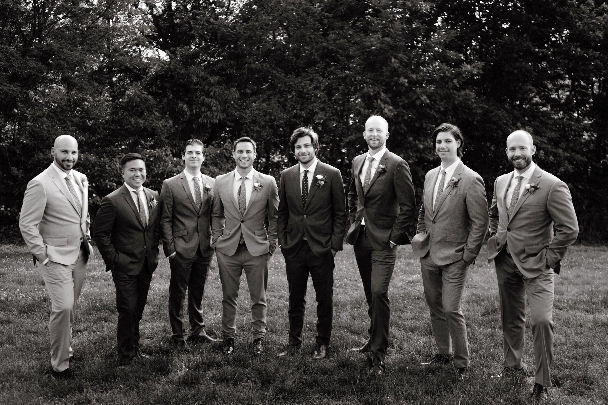 The groom is standing in the middle of his groomsmen in NYC. Image by Jenny Fu Studio