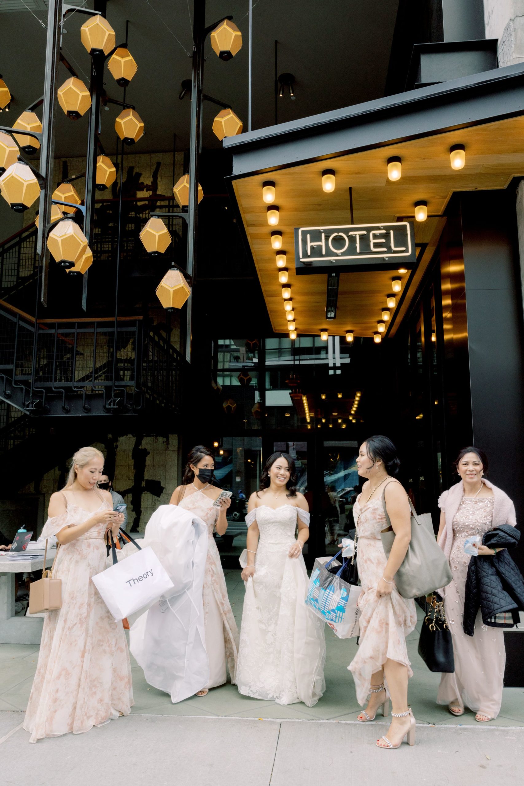 The bride and her bridesmaids are coming out of the hotel. Image by Jenny Fu Studio