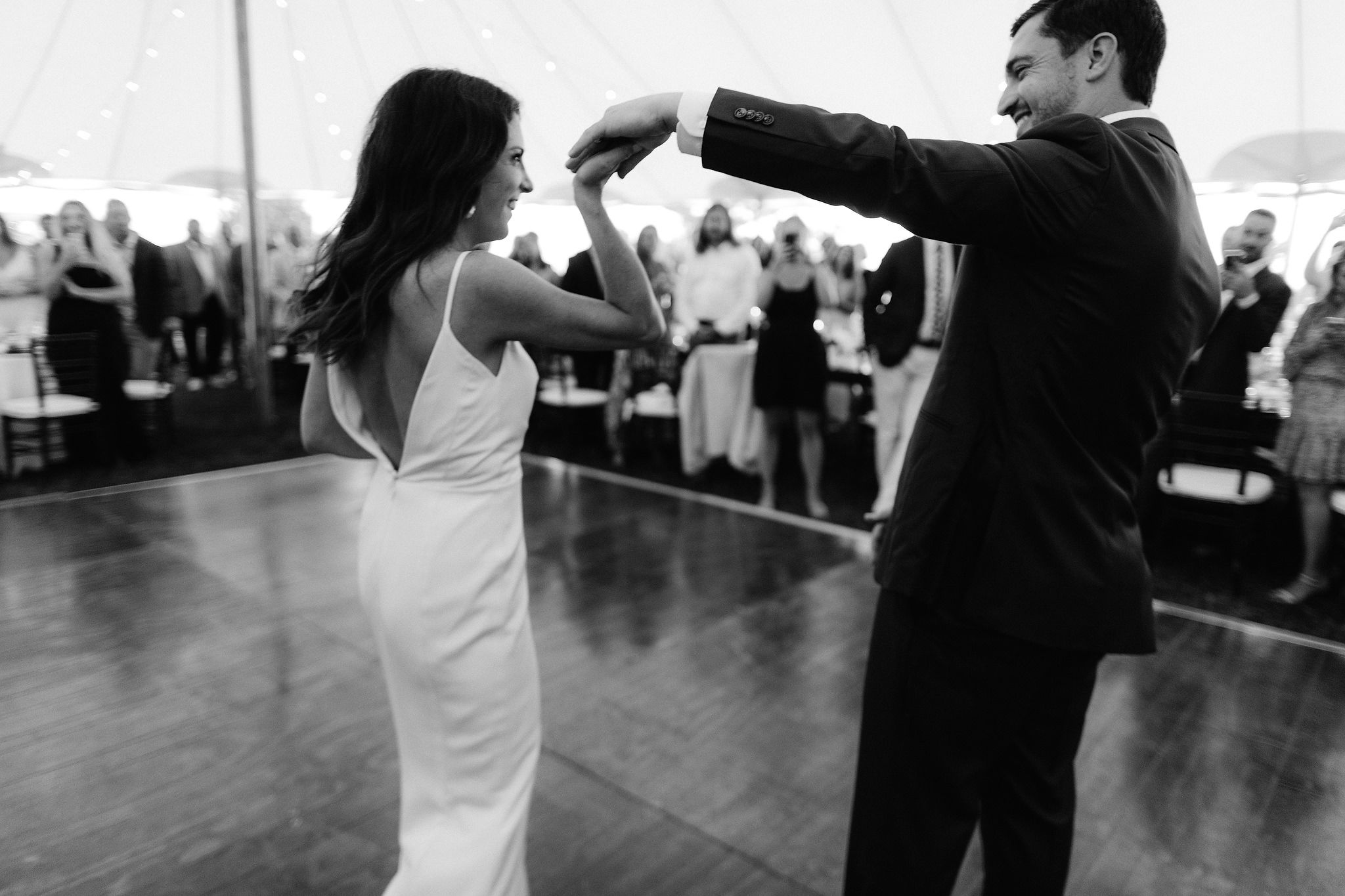 The bride and groom are doing their first dance. Wianno Club, Cape Cod, Osterville, MA. Beach wedding venue image by Jenny Fu Studio