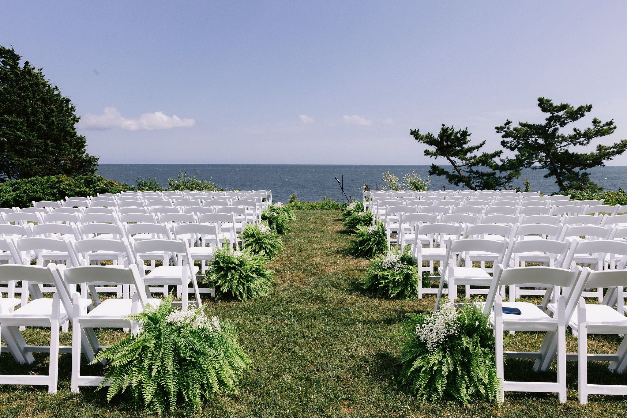 A wedding ceremony set-up with ocean view at Wianno Club, Cape Cod, Osterville, MA. Beach wedding venue image by Jenny Fu Studio