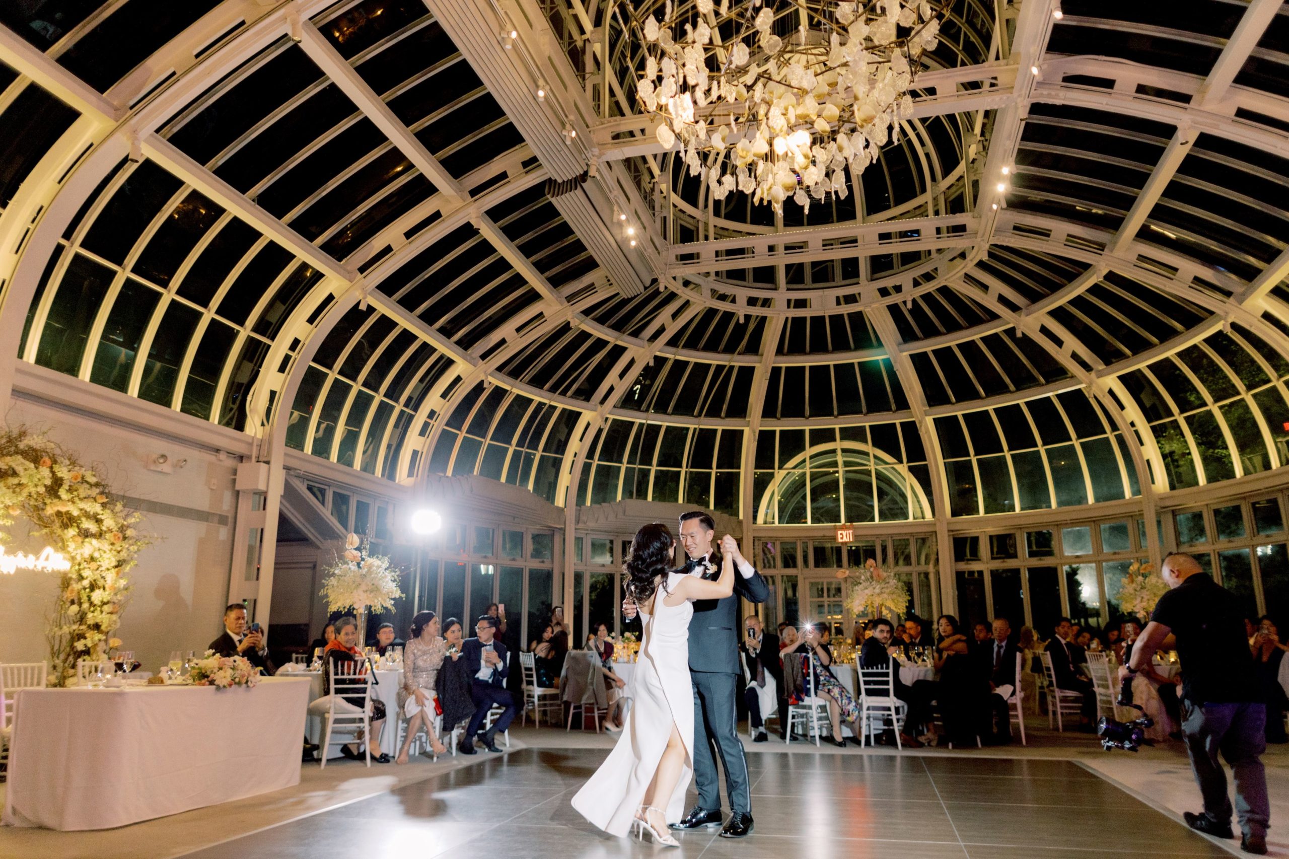 The bride and groom are doing their first dance in The Brooklyn Botanical Garden. Image by Jenny Fu Studio