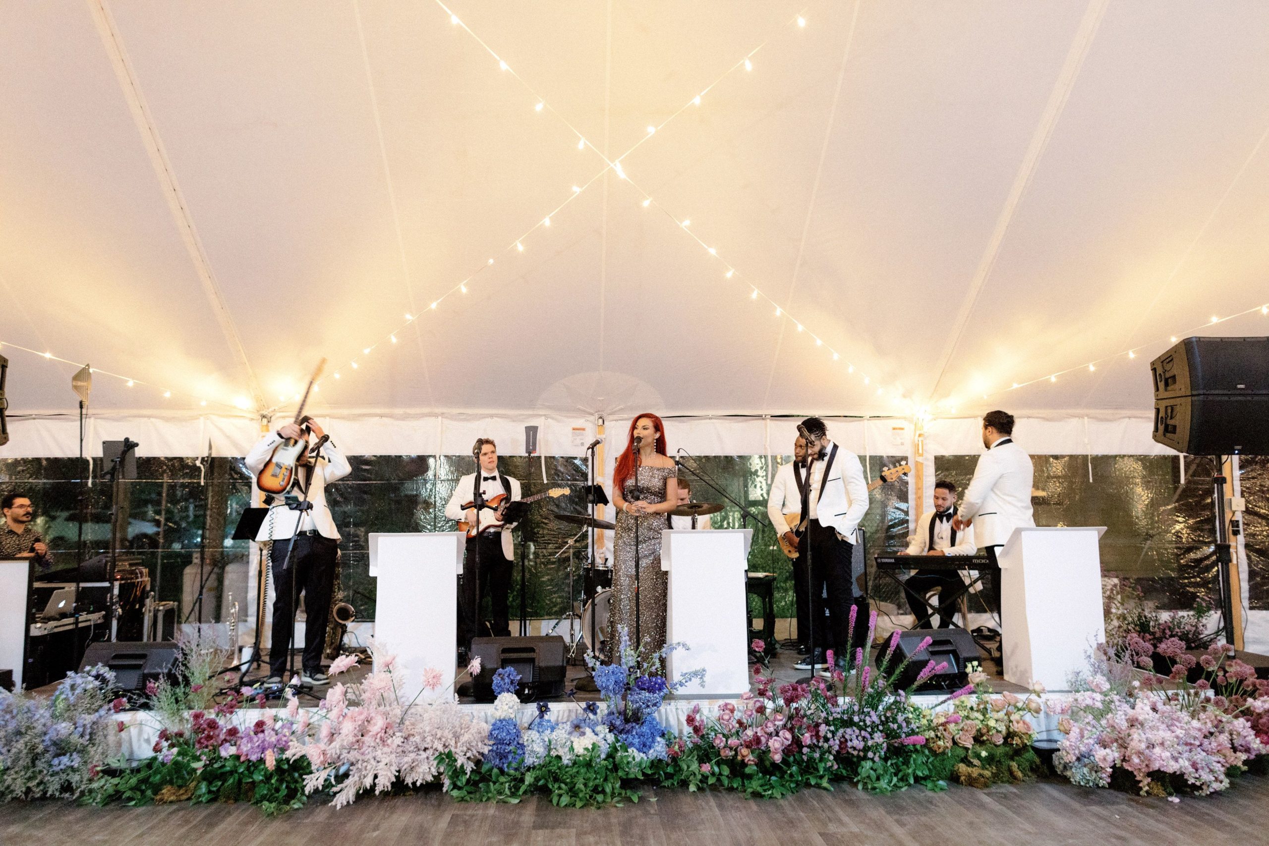 The band is playing on the stage for a wedding at The Ausable Club. Best NYC wedding vendors Image by Jenny Fu Studio.