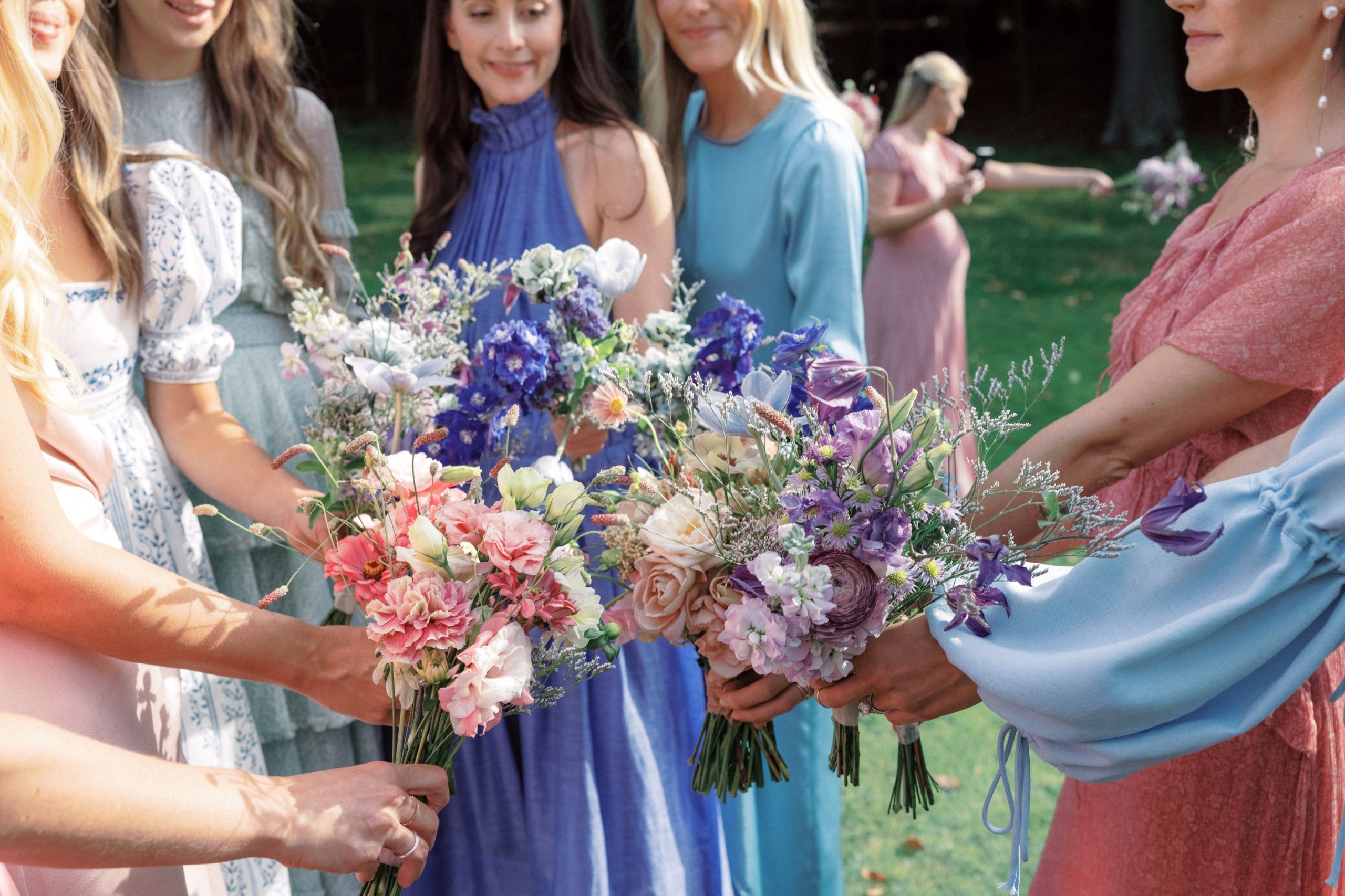 The bridesmaids are holding beautiful flowers at The Ausable Club. Best NYC wedding vendors Image by Jenny Fu Studio