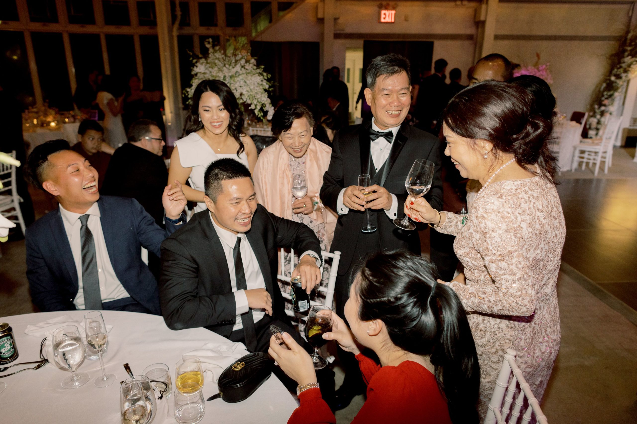 The bride and a group of guests are having a fun time at the reception. Image by Jenny Fu Studio