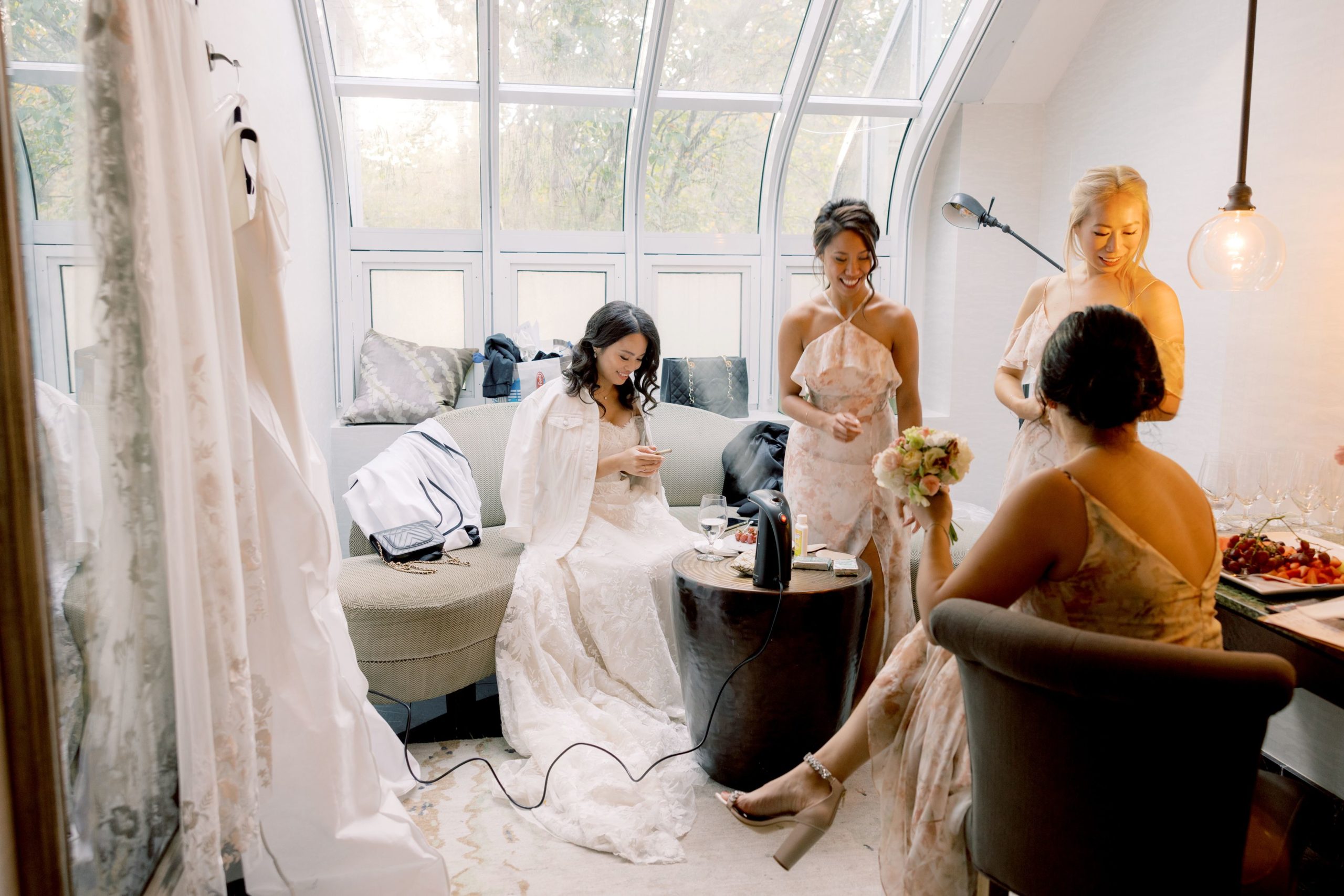 The bride and her bridesmaids are preparing for the ceremony in a room inside The Brooklyn Botanic Garden. Image by Jenny Fu Studio