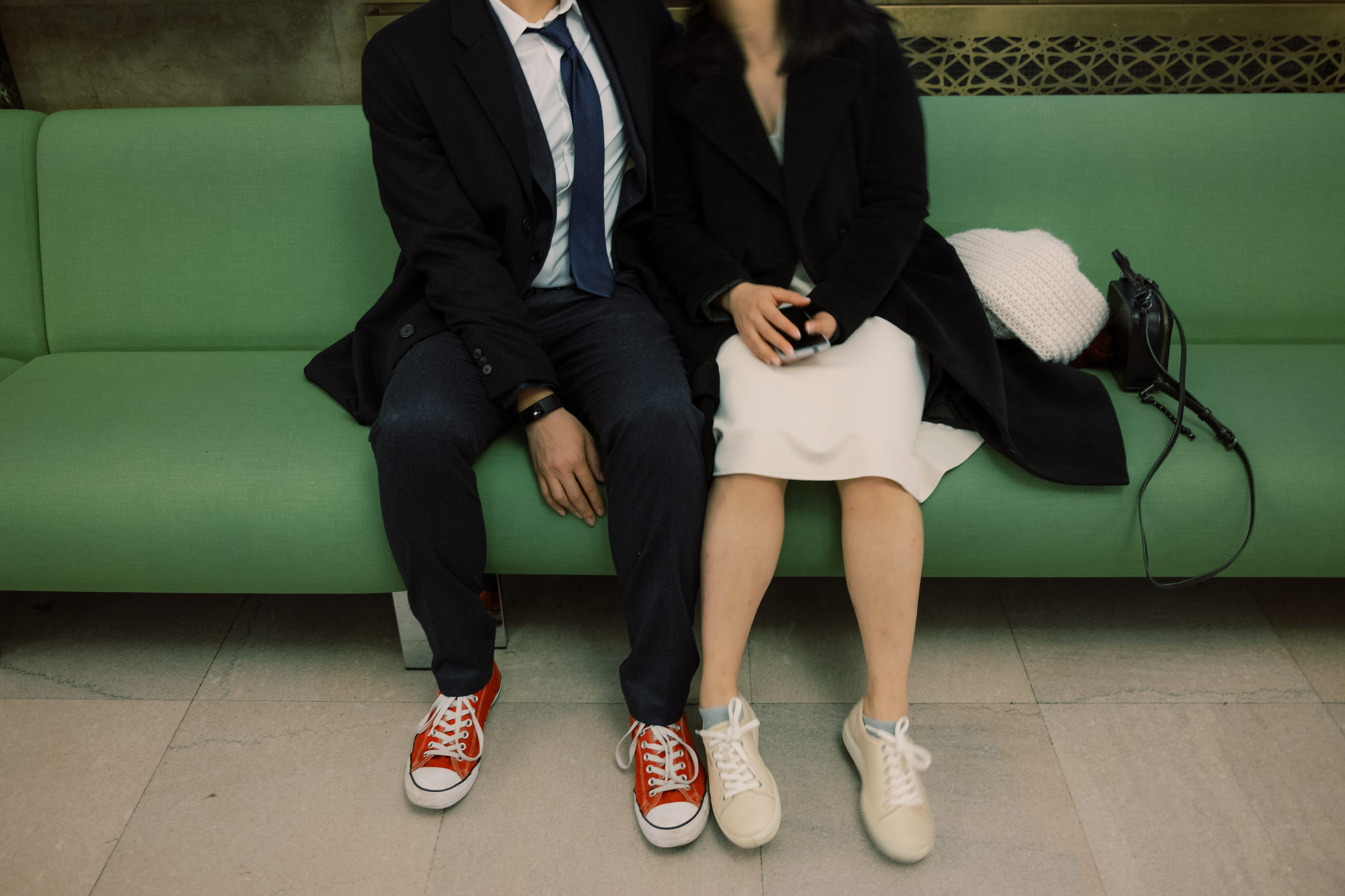 The bride and groom are both wearing sneakers inside NYC City Hall for their 2022 city hall wedding in NYC. 