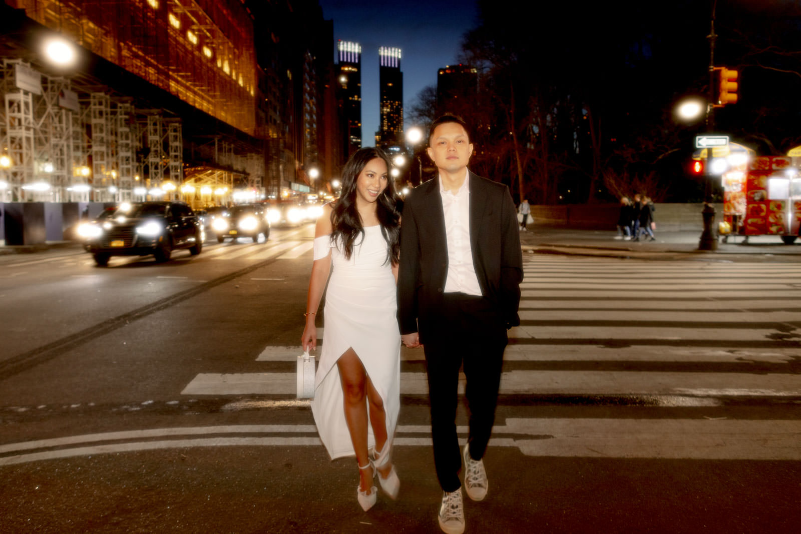 The engaged couple just crossed the street in New York City. Night engagement photos by Jenny Fu Studio