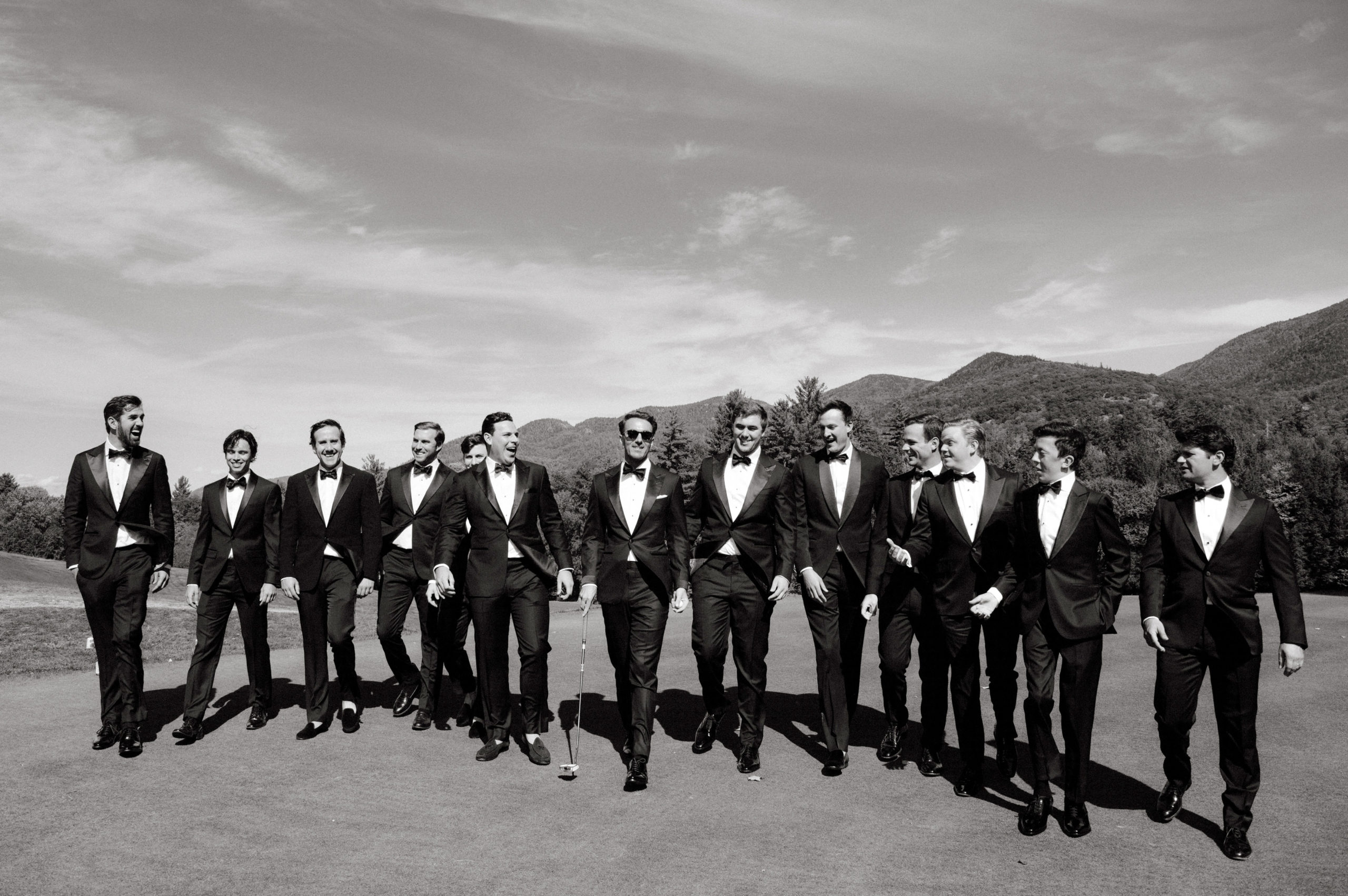 The groom together with his groomsmen, with The Adirondack Mountains in the background. Image by Jenny Fu Studio
