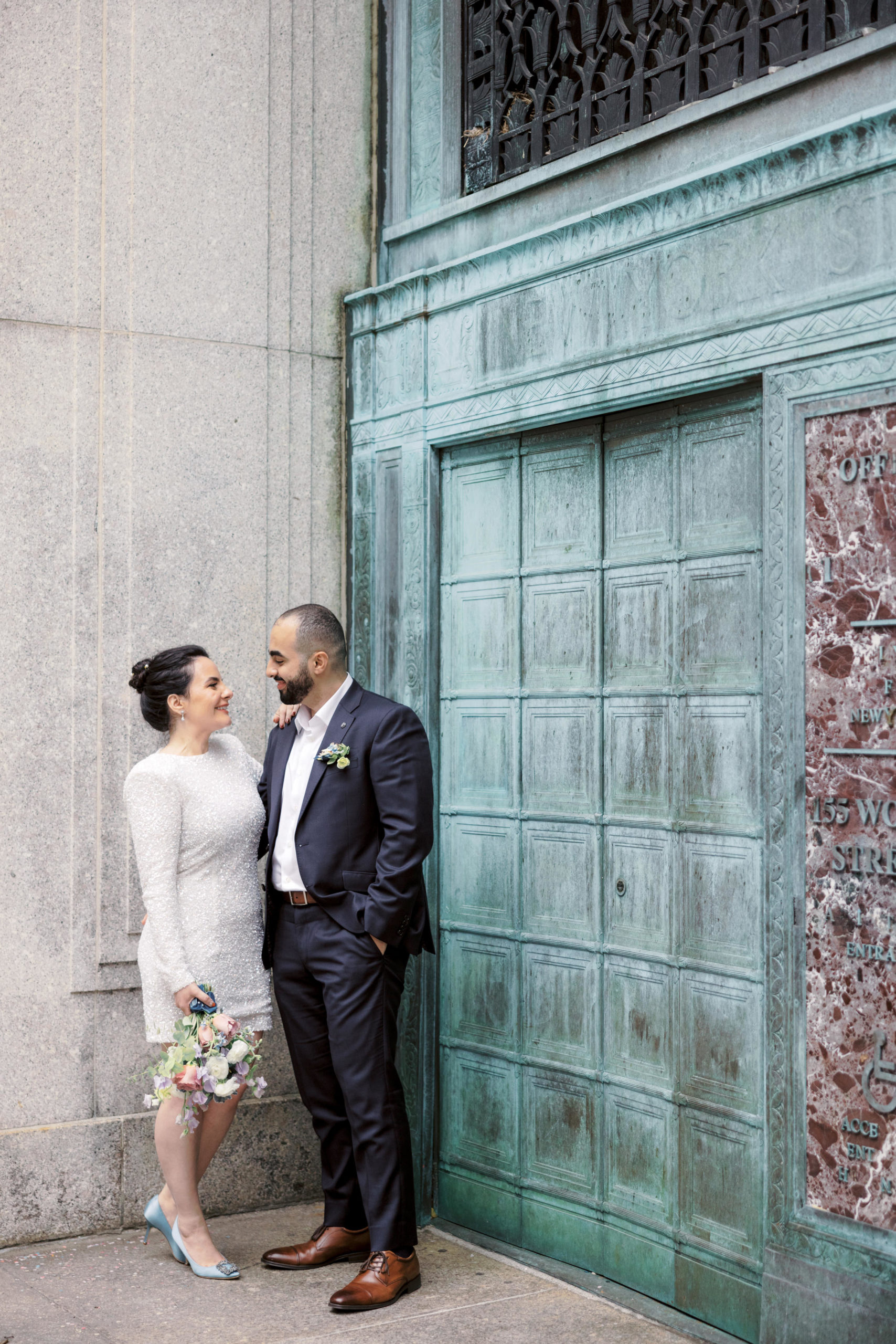 The bride and groom are happily staring at each other's eyes after their city hall elopement. Image by Jenny Fu Studio NYC