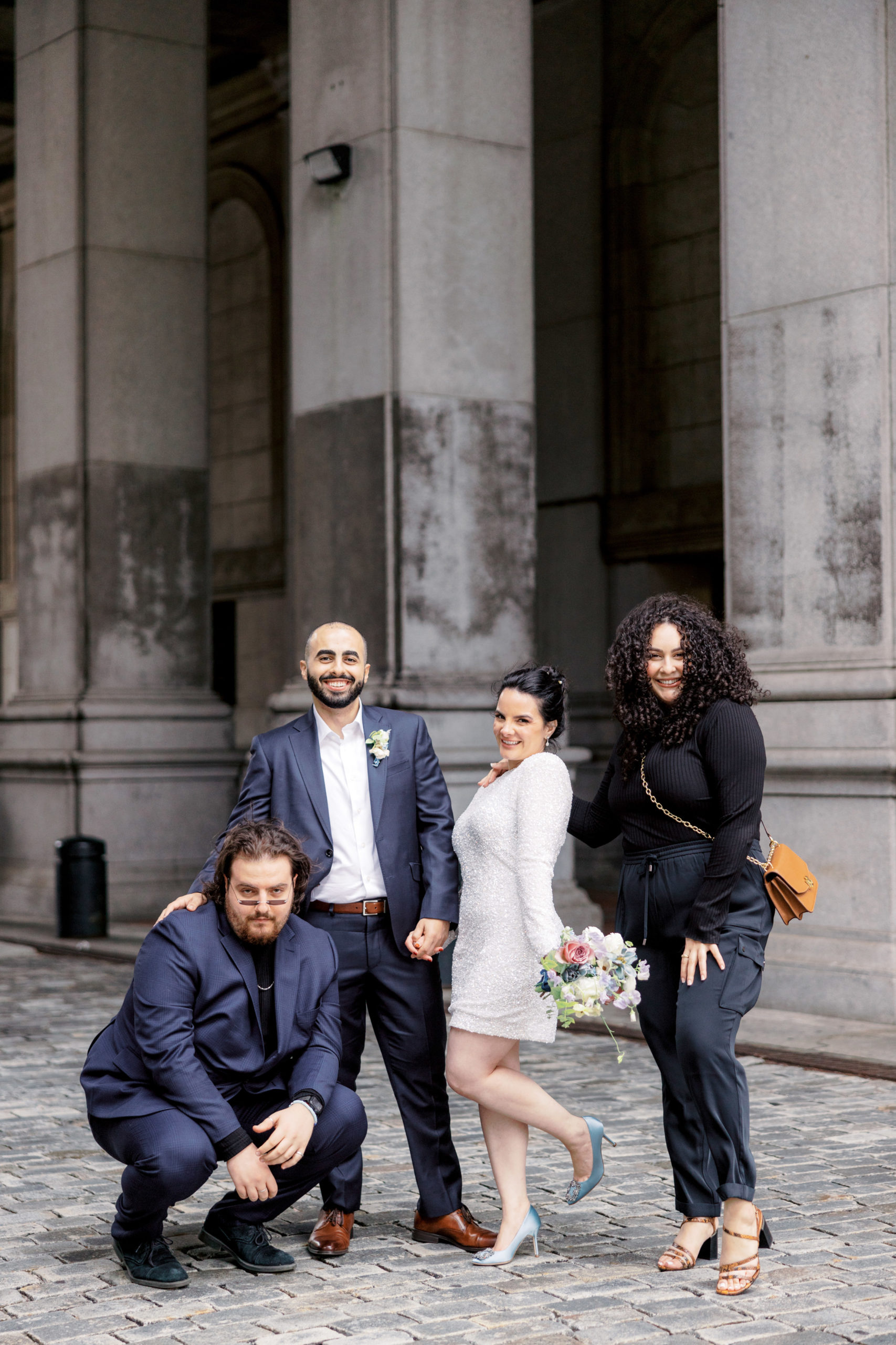The bride and groom are happy with their two friends after their city hall elopement. Image by Jenny Fu Studio NYC