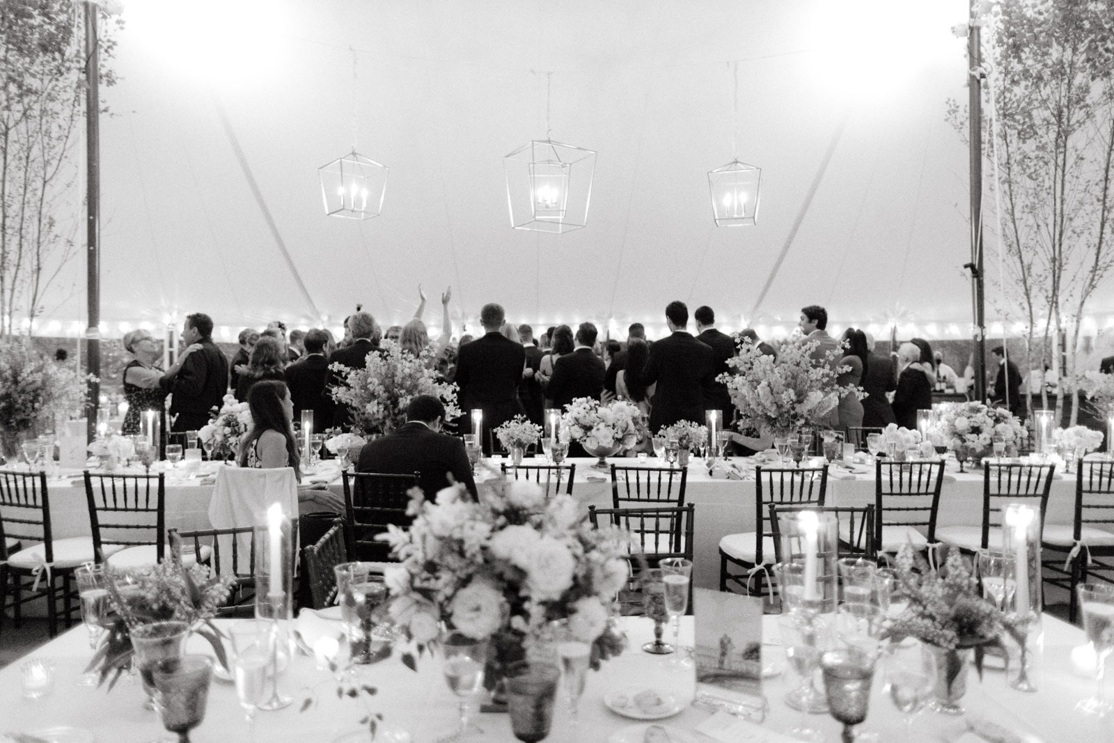 The guests are dancing in a wedding reception at the Lion Rock Farm. Destination wedding image by Jenny Fu Studio