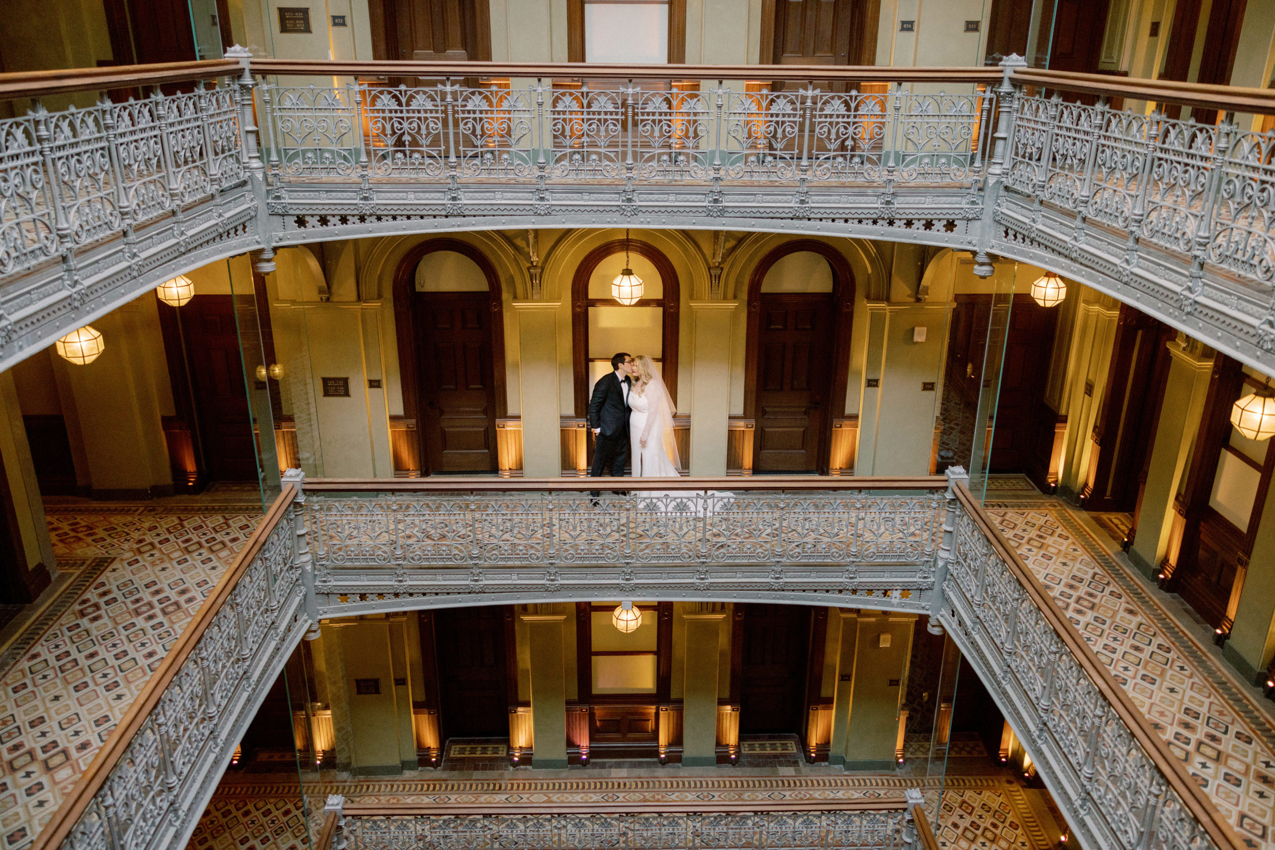 The groom is kissing the bride in a beautiful hotel. NYC wedding venue image by Jenny Fu Studio