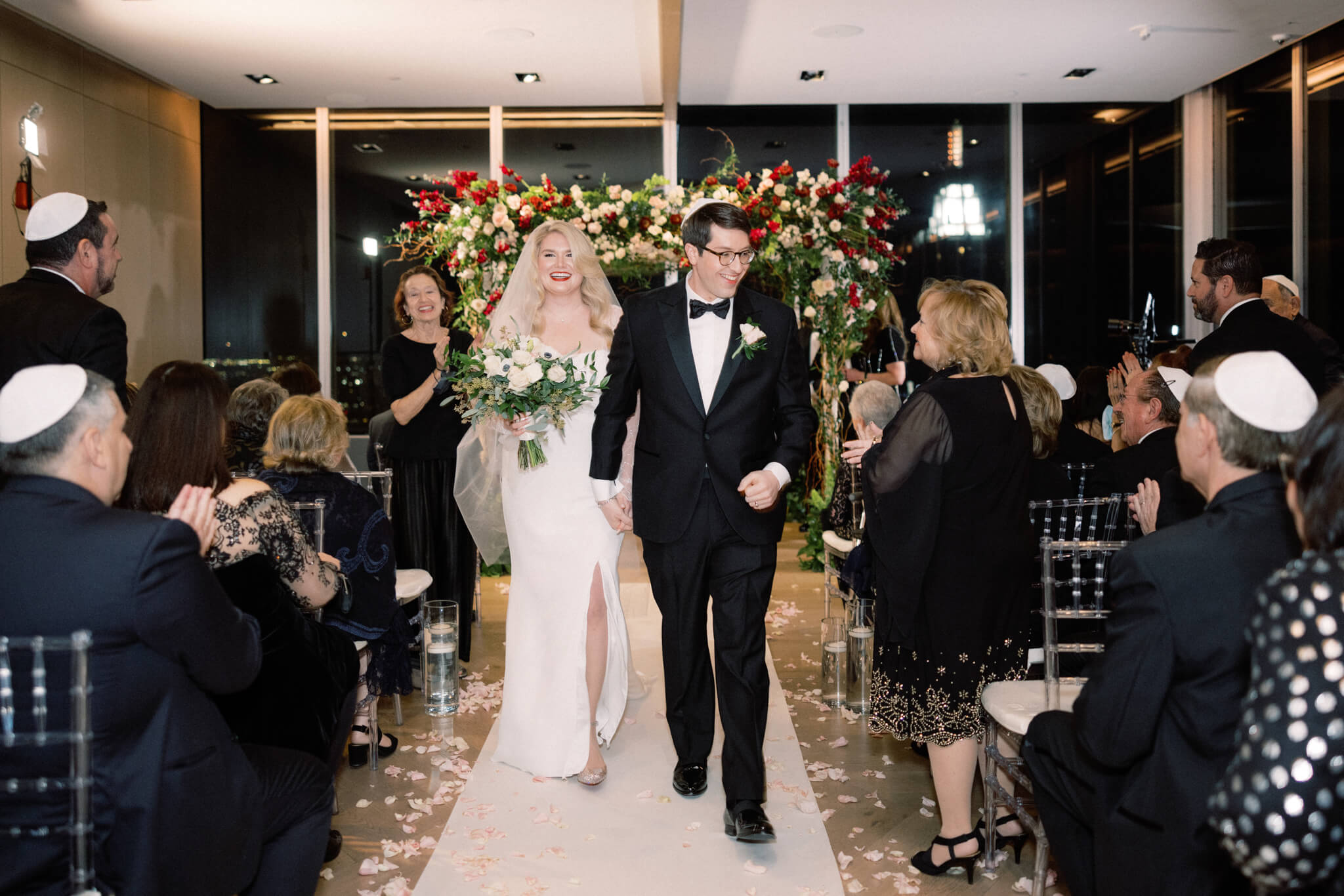 Editorial photo of the bride and groom walking away from the aisle after their wedding ceremony at Manhatta Restaurant, NYC. Image by Jenny Fu Studio