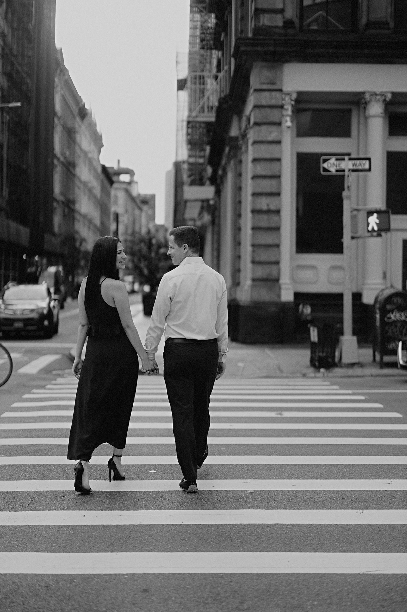 The couple is crossing the street in New York City. Editorial engagement photo by Jenny Fu Studio