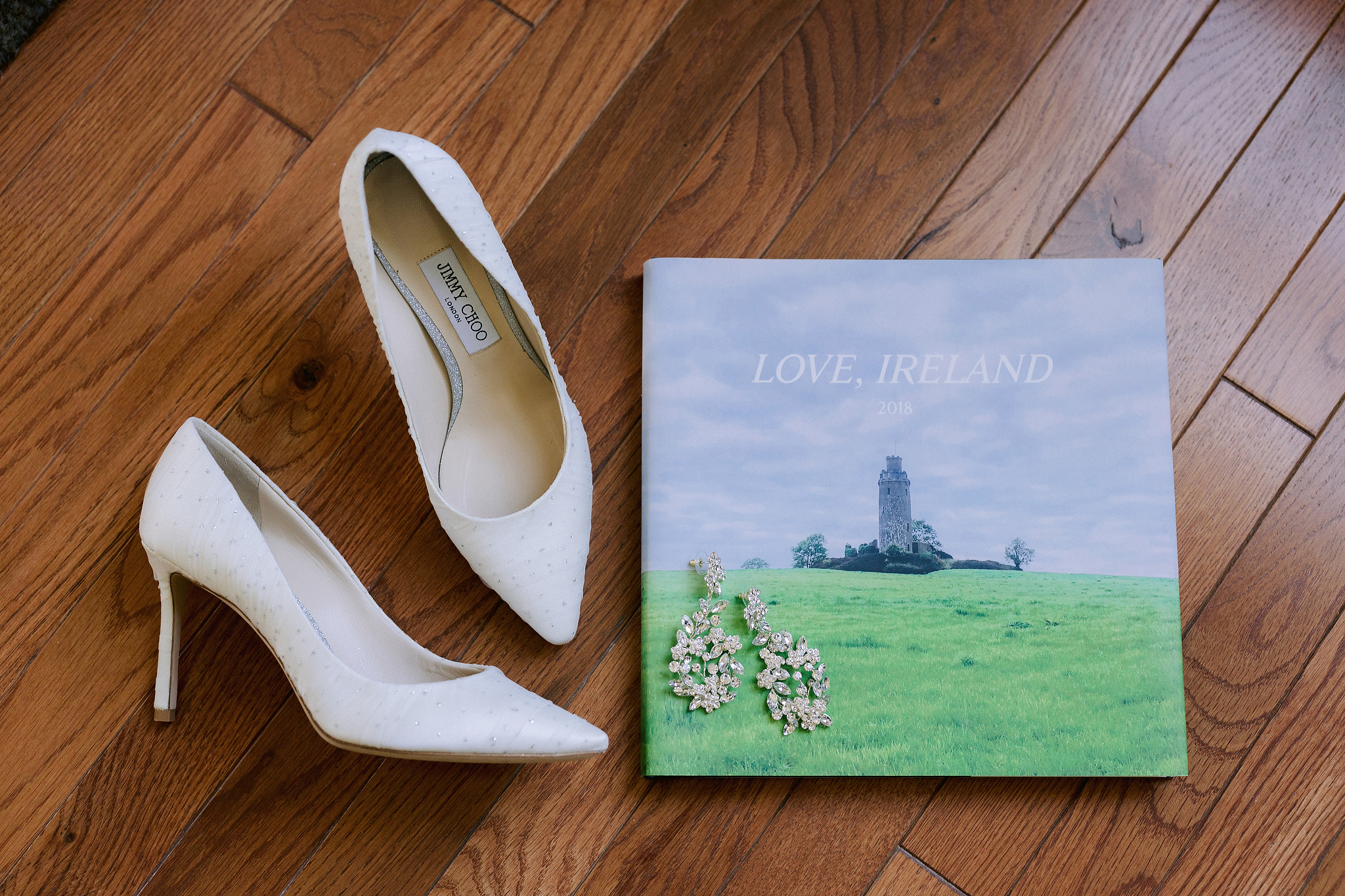 The bride's wedding shoes and earrings. Editorial destination wedding image by Jenny Fu Studio. 
