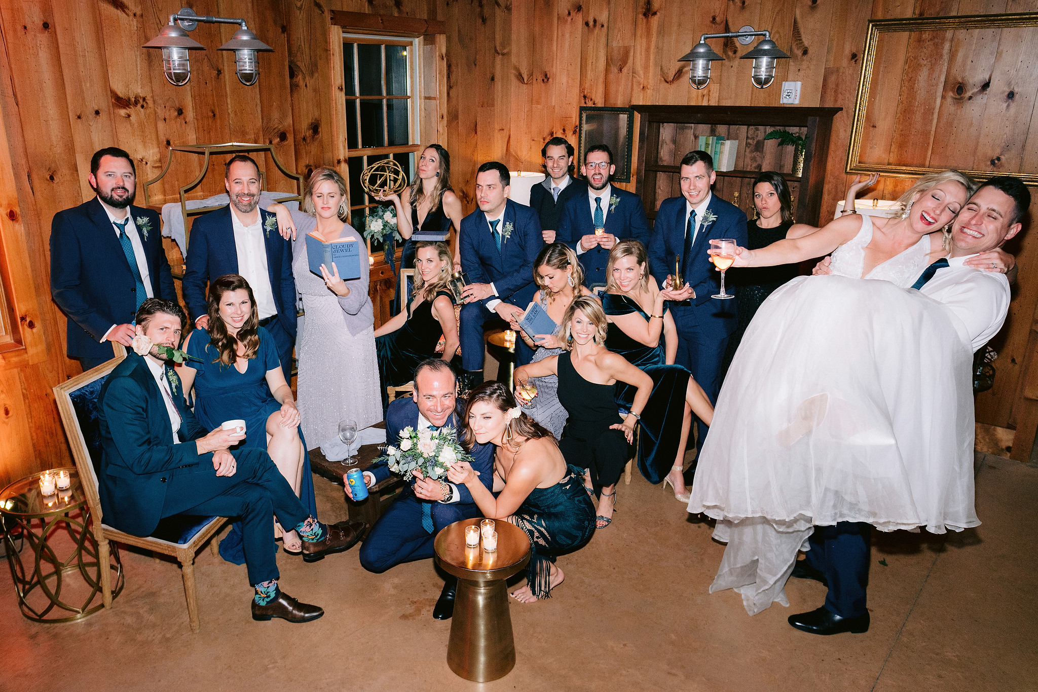 The bride, groom, and wedding party are having a good time at the wedding reception. Editorial destination wedding image by Jenny Fu Studio.