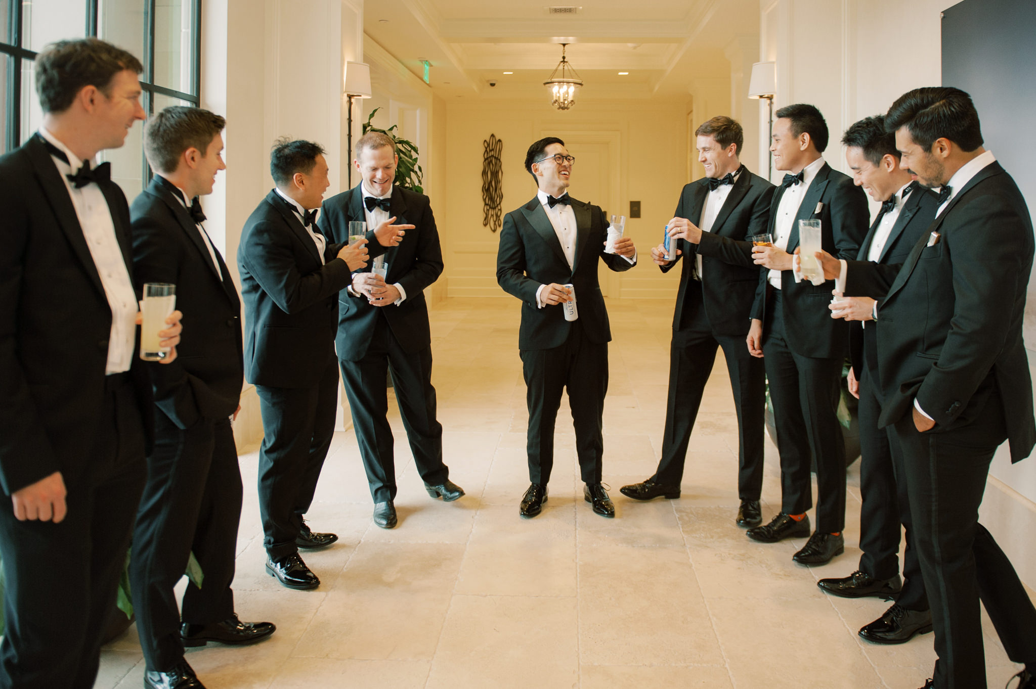 The groomsmen are laughing, chatting and drinking while waiting for the wedding ceremony. Image by Jenny Fu Studio
