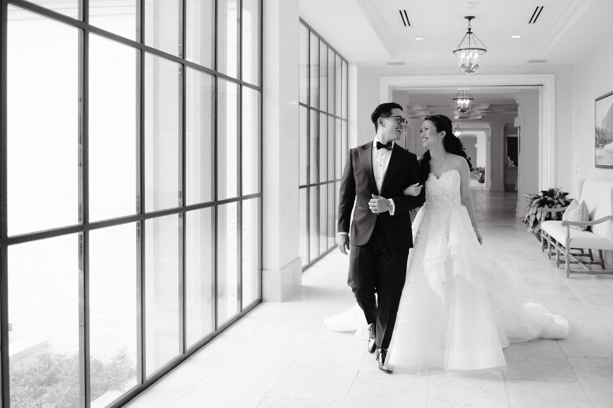 The bride and groom are happily walking in the hallway. Wedding venue image by Jenny Fu Studio
