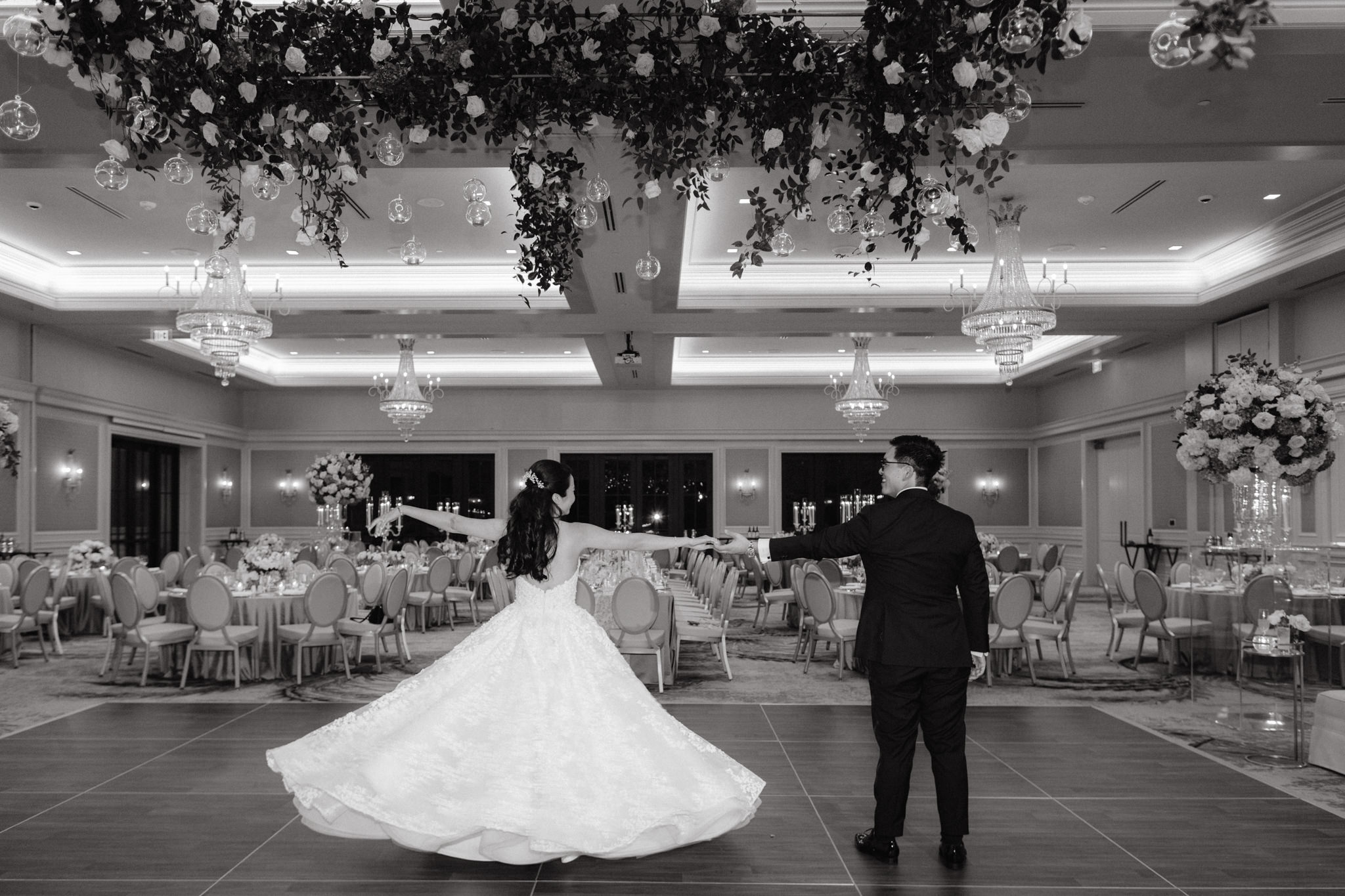 Black and white image of the bride and groom dancing on the dance floor. Image by Jenny Fu Studio