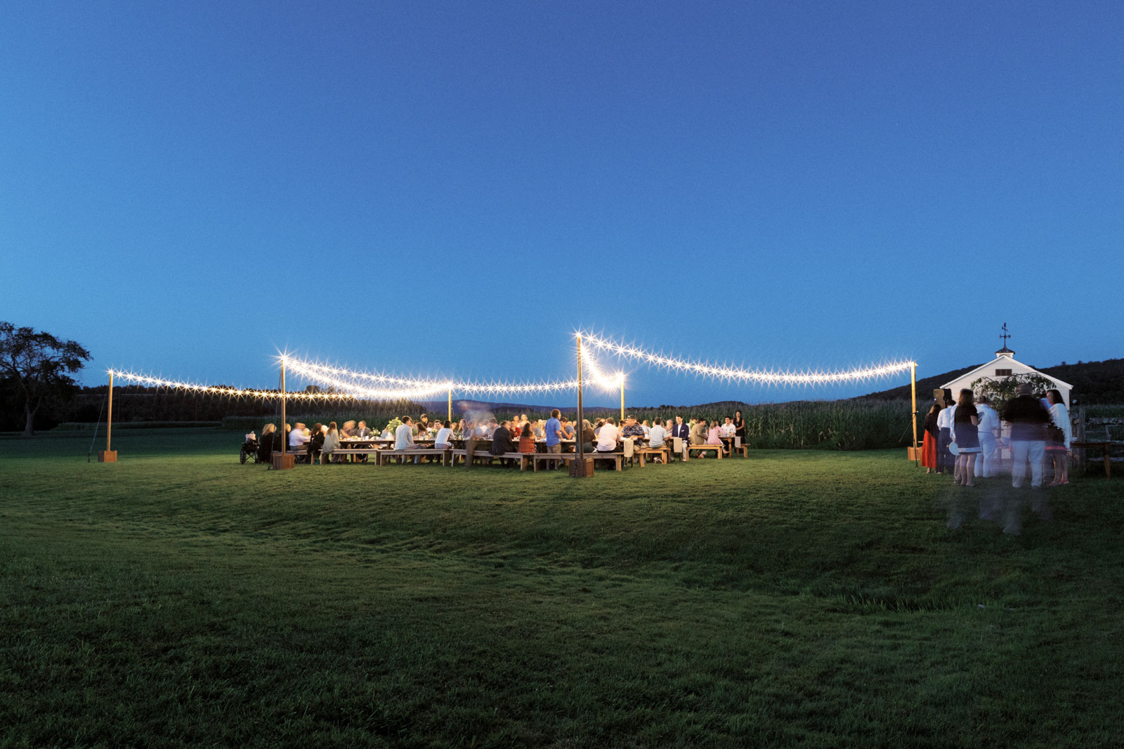 The guests are seated in a pretty outdoor set-up. Editorial rehearsal dinner image by Jenny Fu Studio