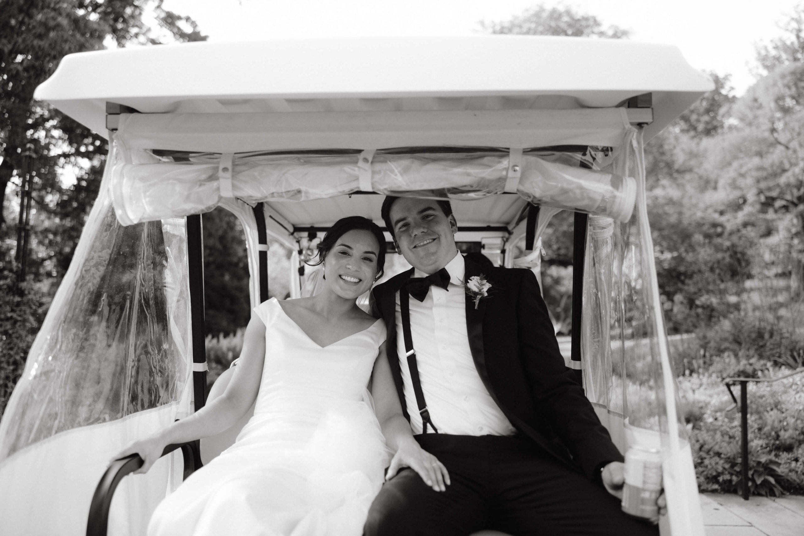 The bride and groom are happily riding the golf cart, going to their wedding. Destination wedding image by Jenny Fu Studio