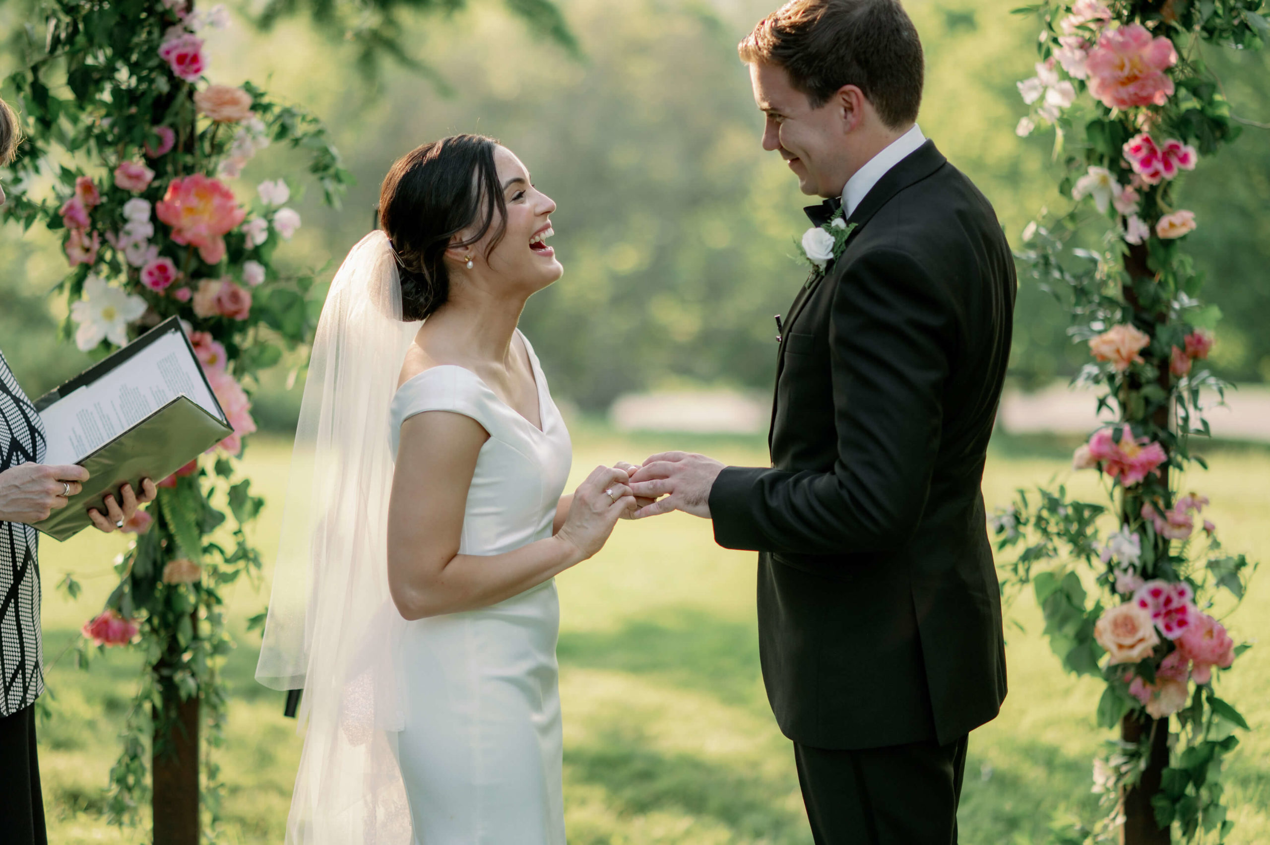 Editorial wedding image of the bride and groom happily exchanging vows. Image by Jenny Fu Studio
