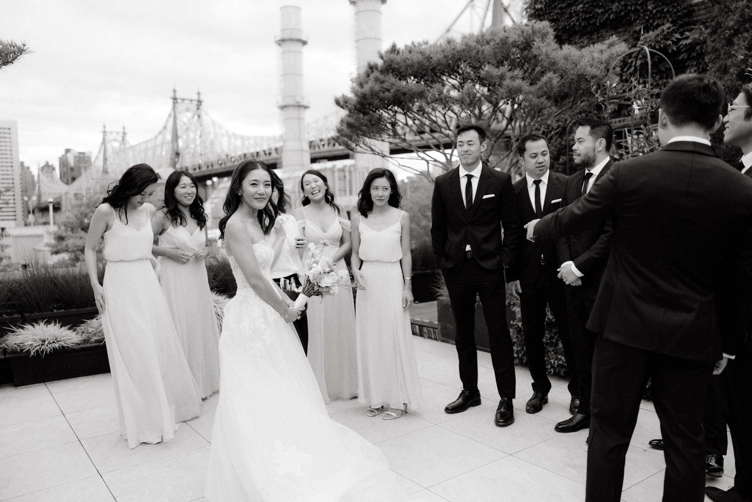 The bride, groom, bridesmaids, and groomsmen are chatting happily. Photojournalistic Photography by Jenny Fu Studio