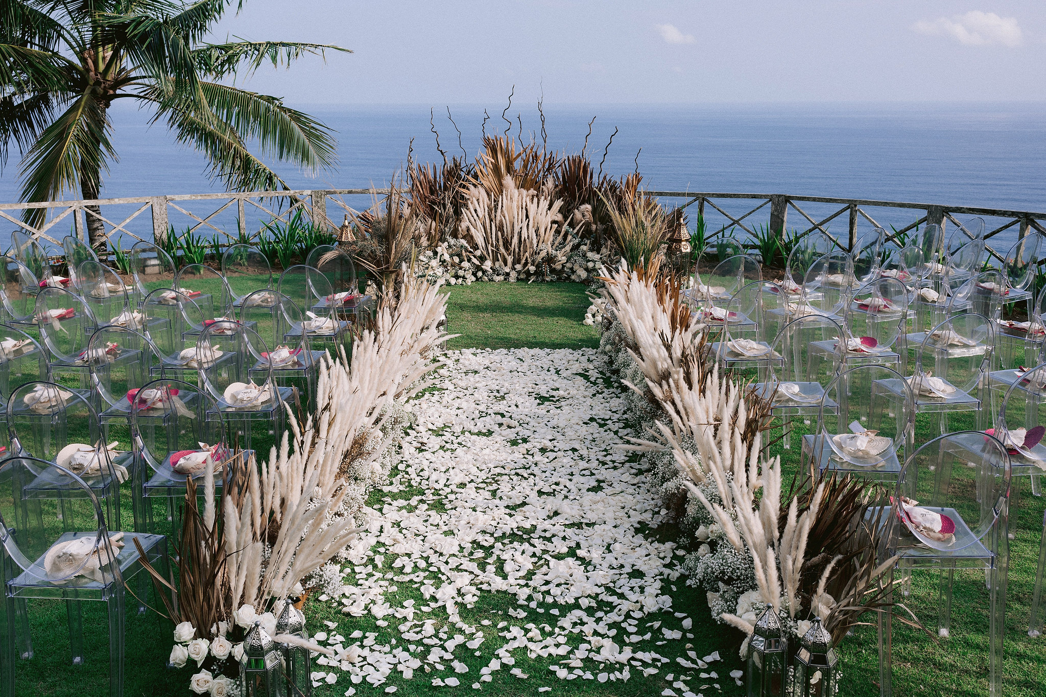 A beautiful ceremony set-up overlooking the ocean at Bali, Indonesia. Destination wedding photo by Jenny Fu Studio