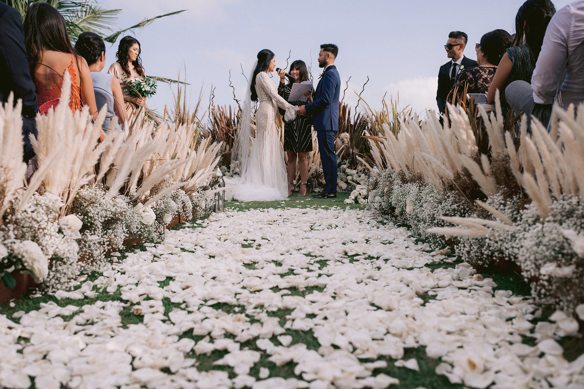 The bride is saying her wedding vows in  a ceremony in Bali, Indonesia. Editorial photo by Jenny Fu Studio