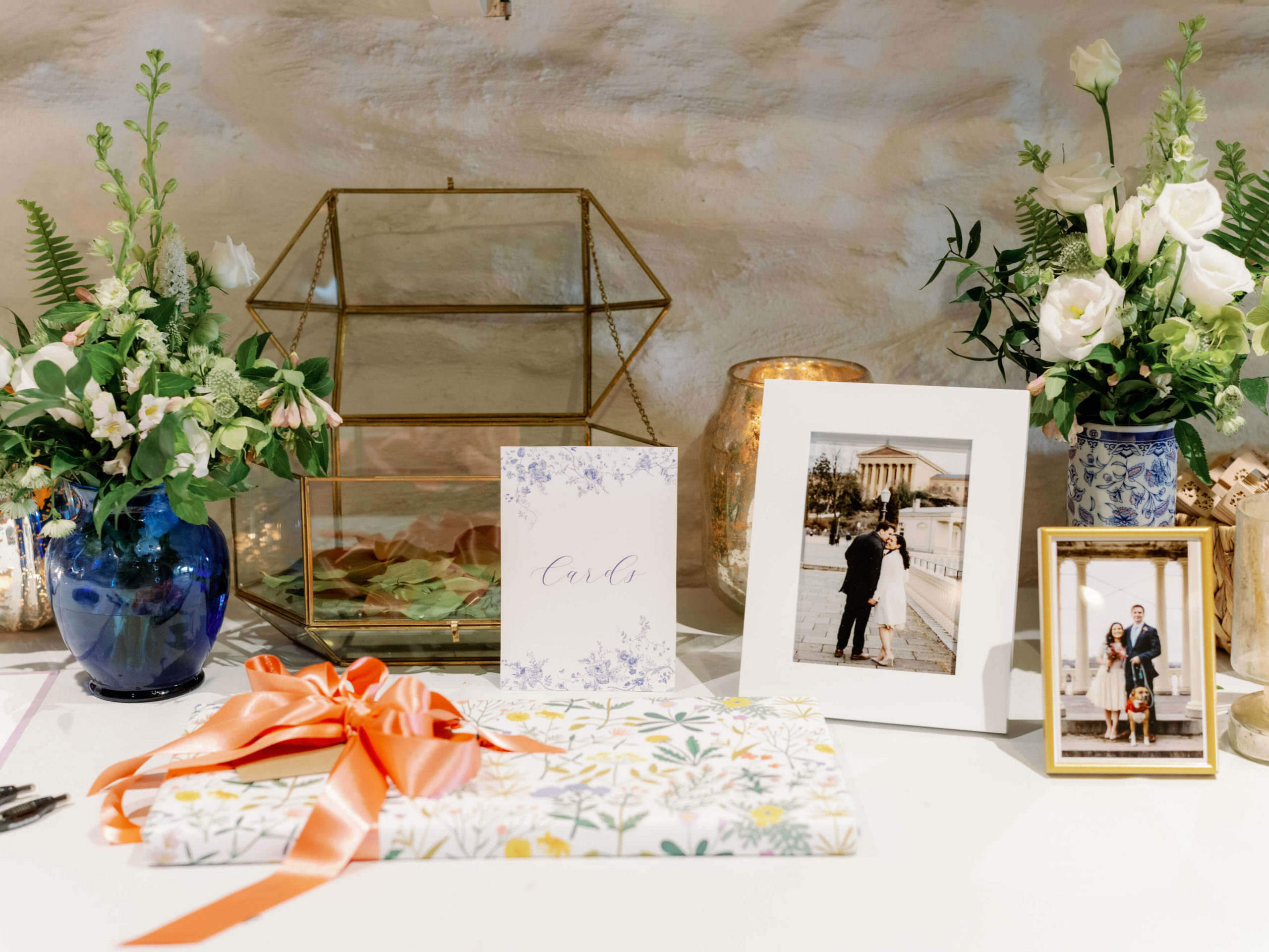 A welcome table with framed engagement photos on it. Editorial engagement photo by Jenny Fu Studio